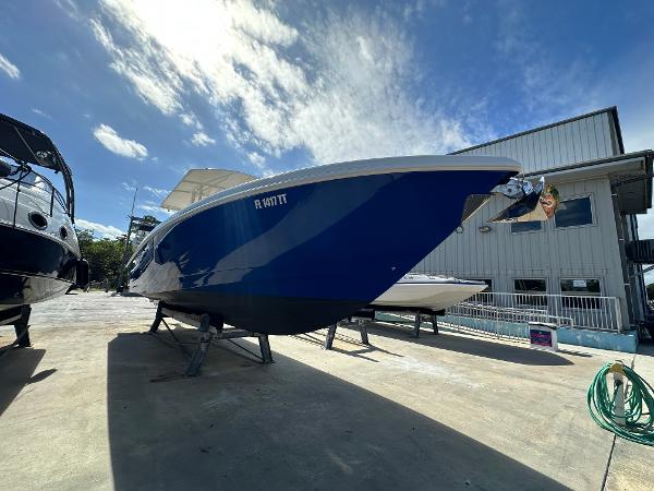 2005 Intrepid 323 boat on display under a clear blue sky.