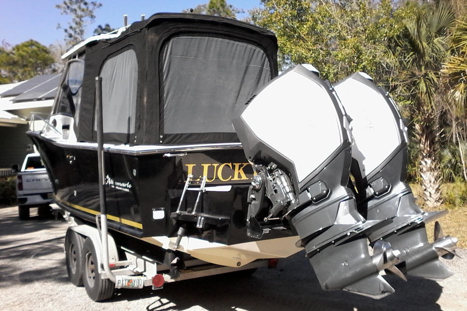 2002 Albemarle 265 Express Fisherman boat with dual outboard motors on a trailer.