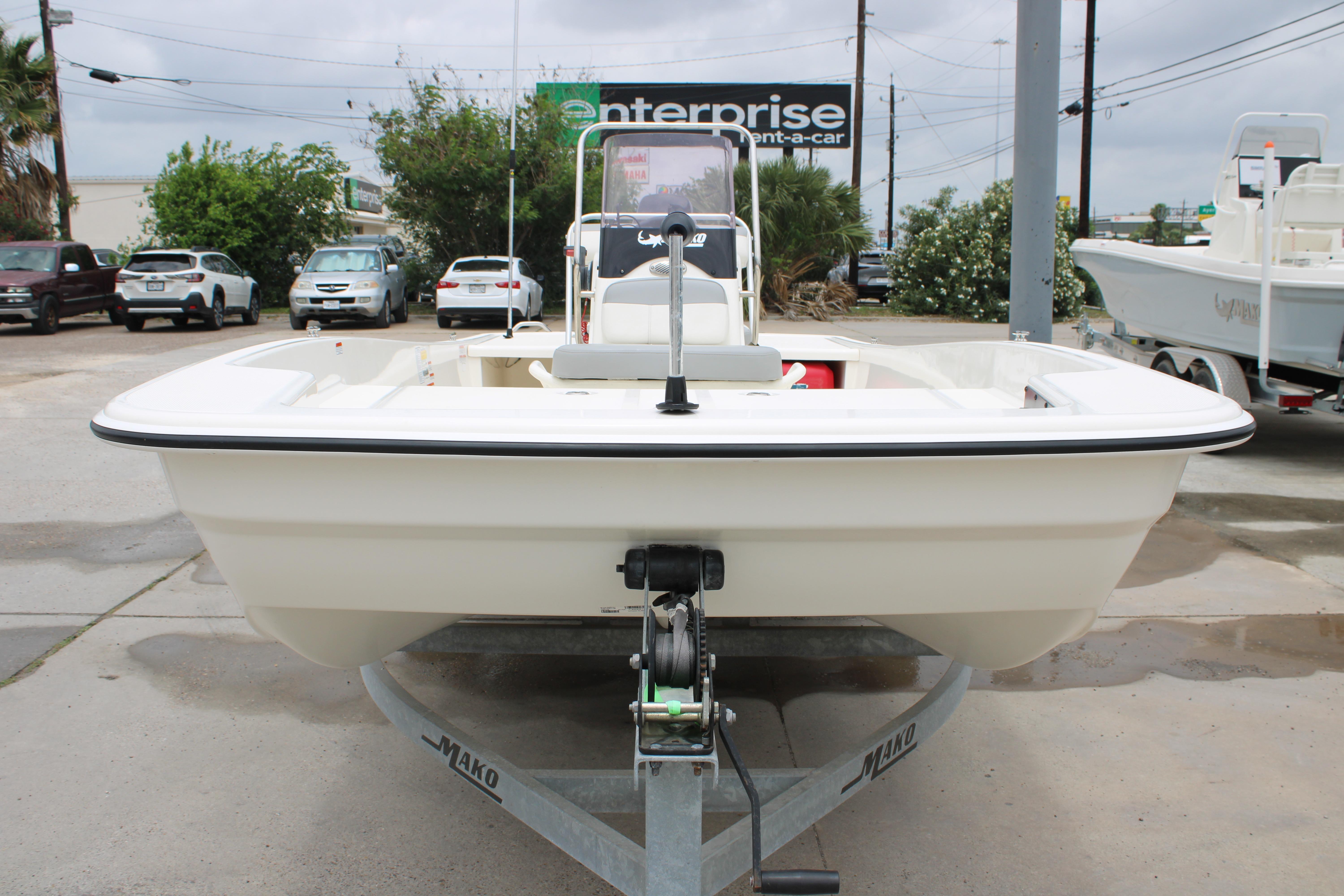 2021 Mako Pro Skiff 17 CC boat on trailer in parking lot.