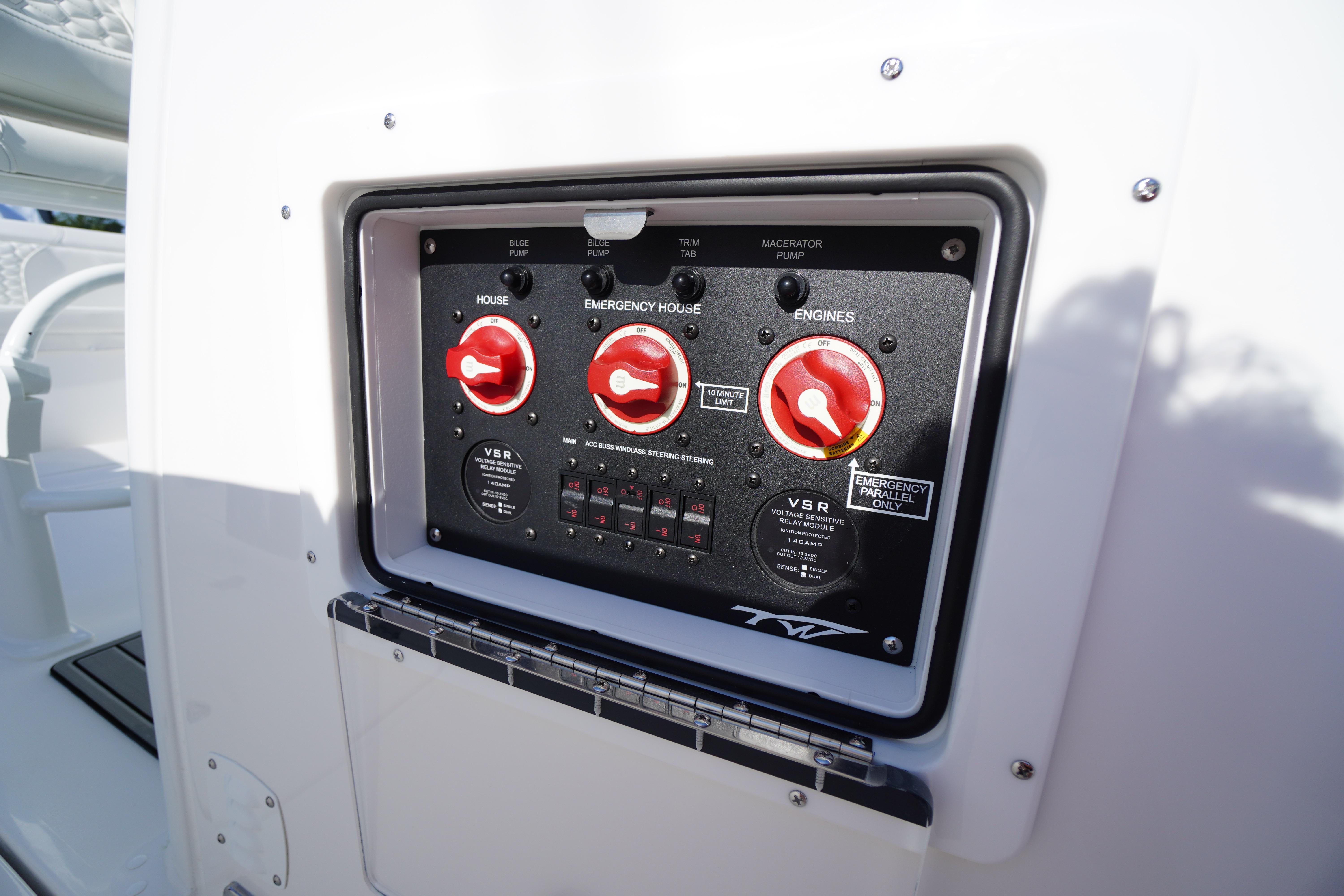 Control panel of 2026 Tidewater 272 LXF boat with red switches and labels.
