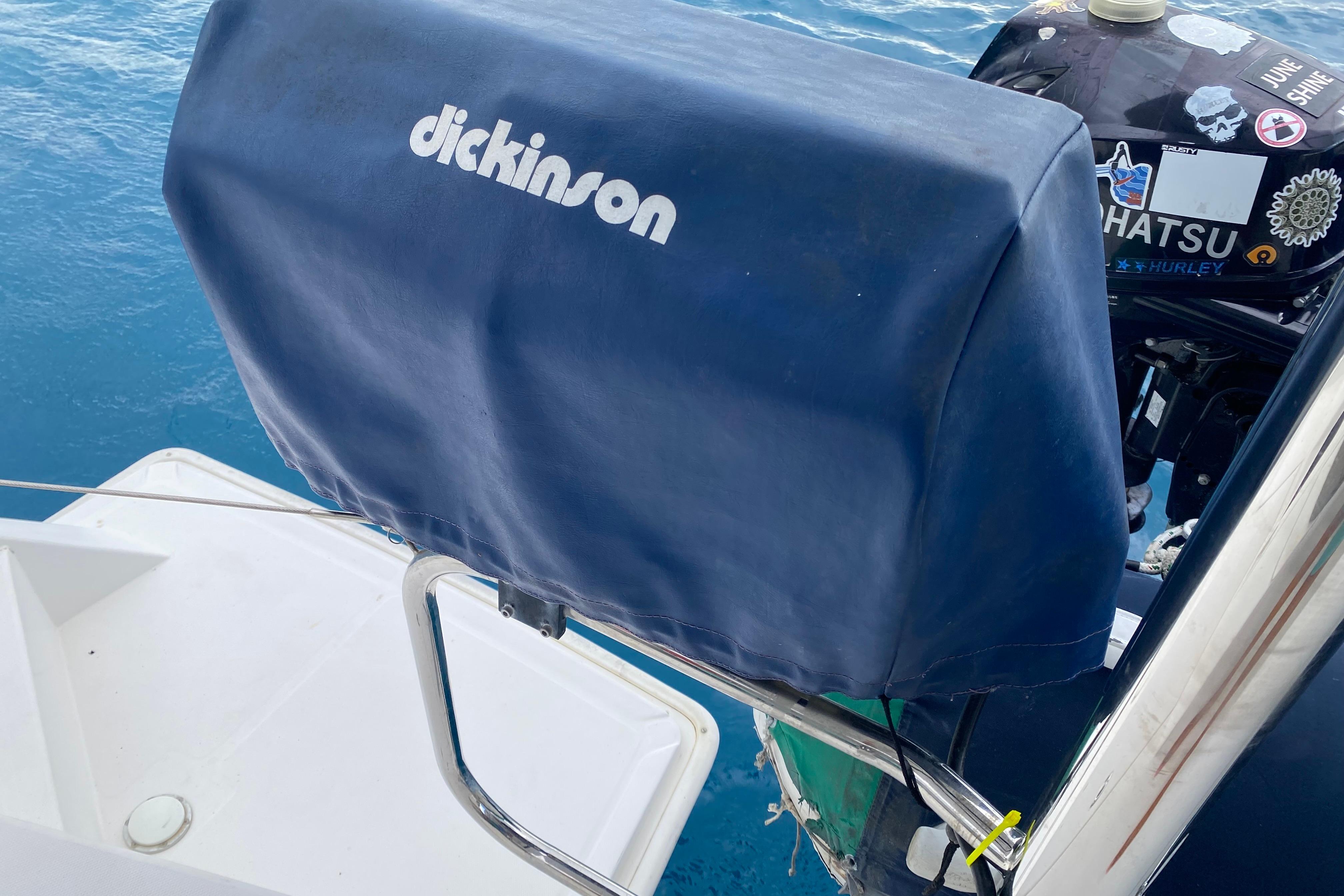 Blue Dickinson grill cover on a 2017 Leopard 40 catamaran, near outboard motor.