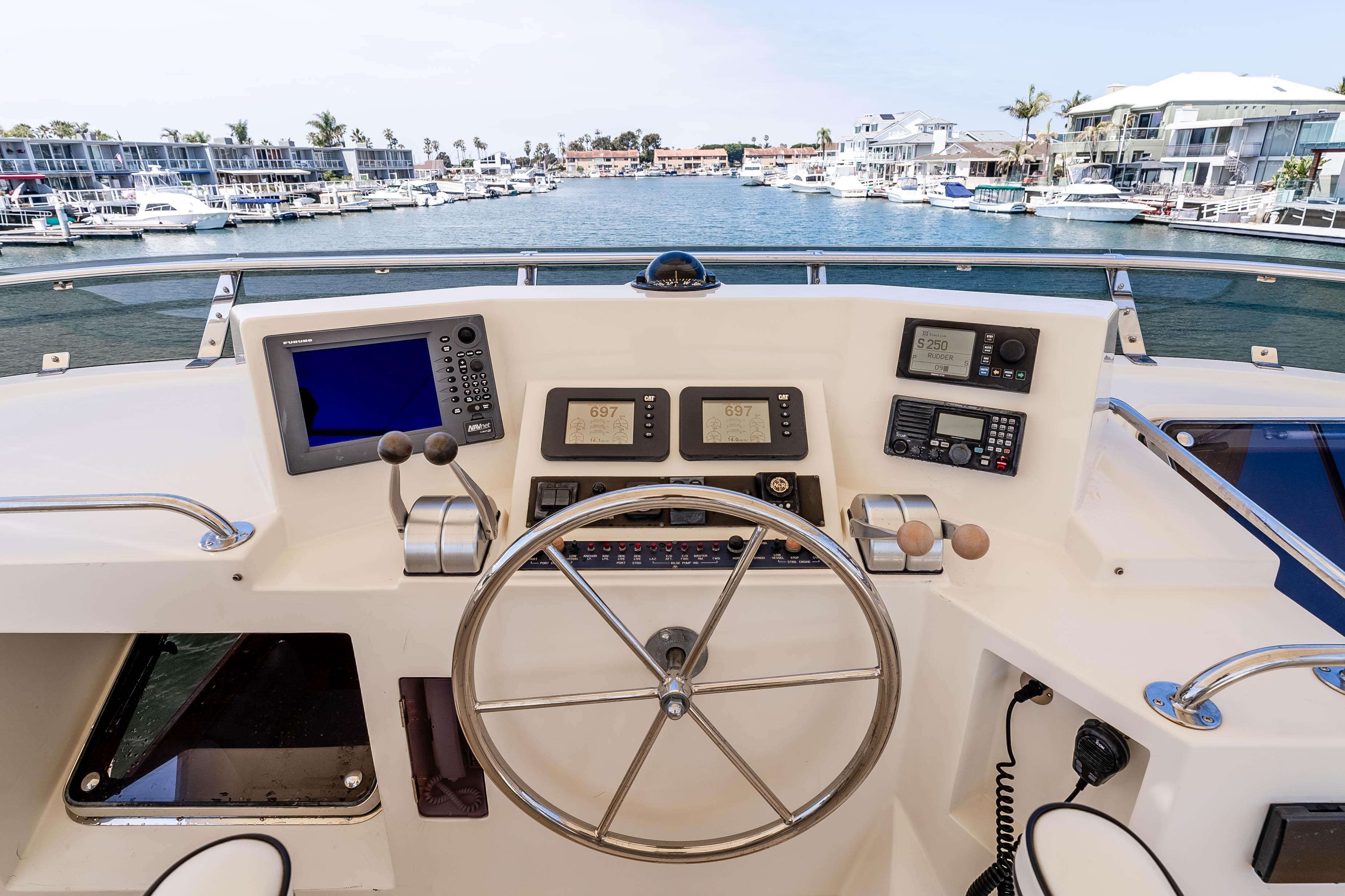 Pilothouse of 2005 Offshore Yachts 54, featuring navigation equipment and steering wheel.