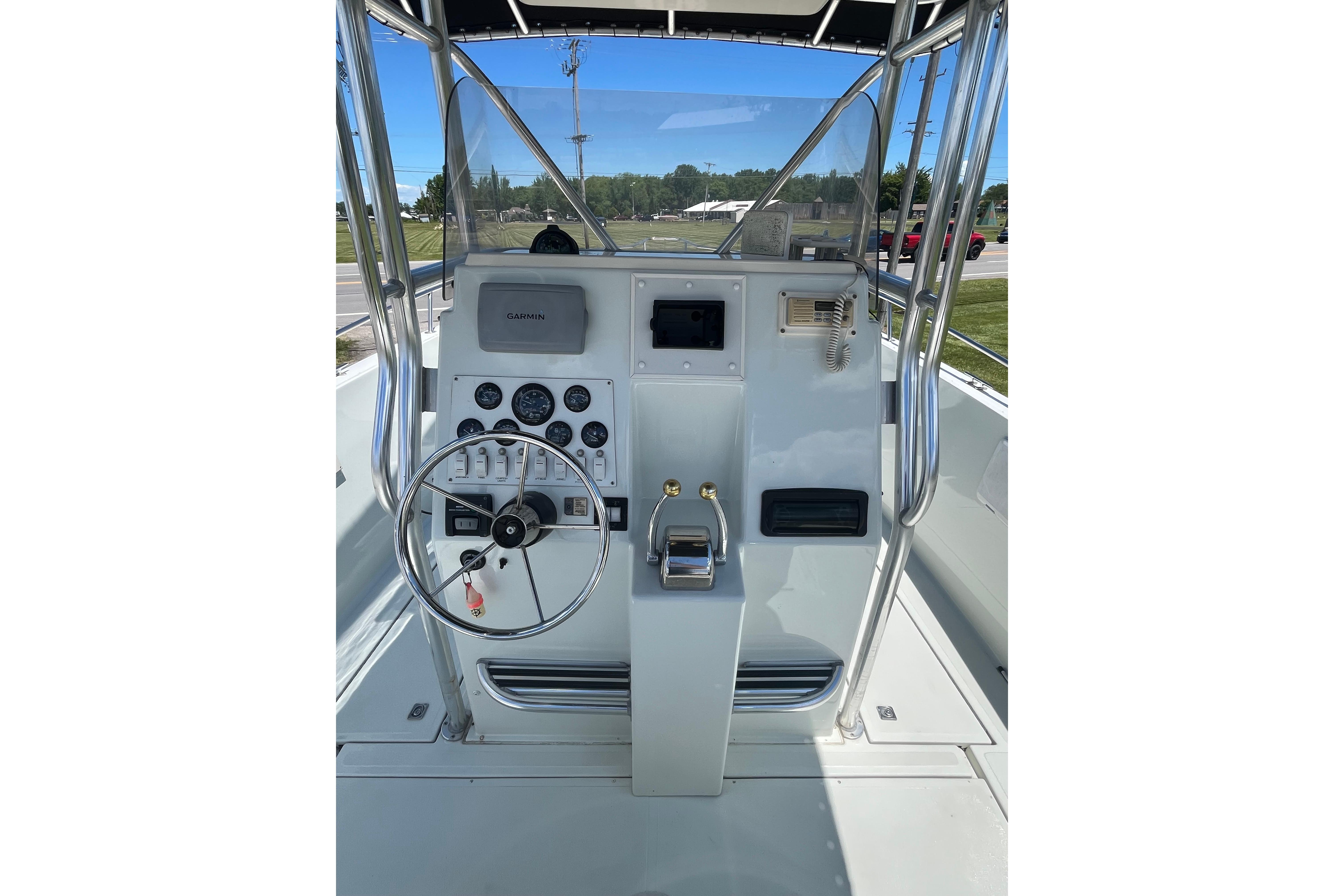 1997 Stamas boat helm with steering wheel, gauges, and Garmin navigation system.