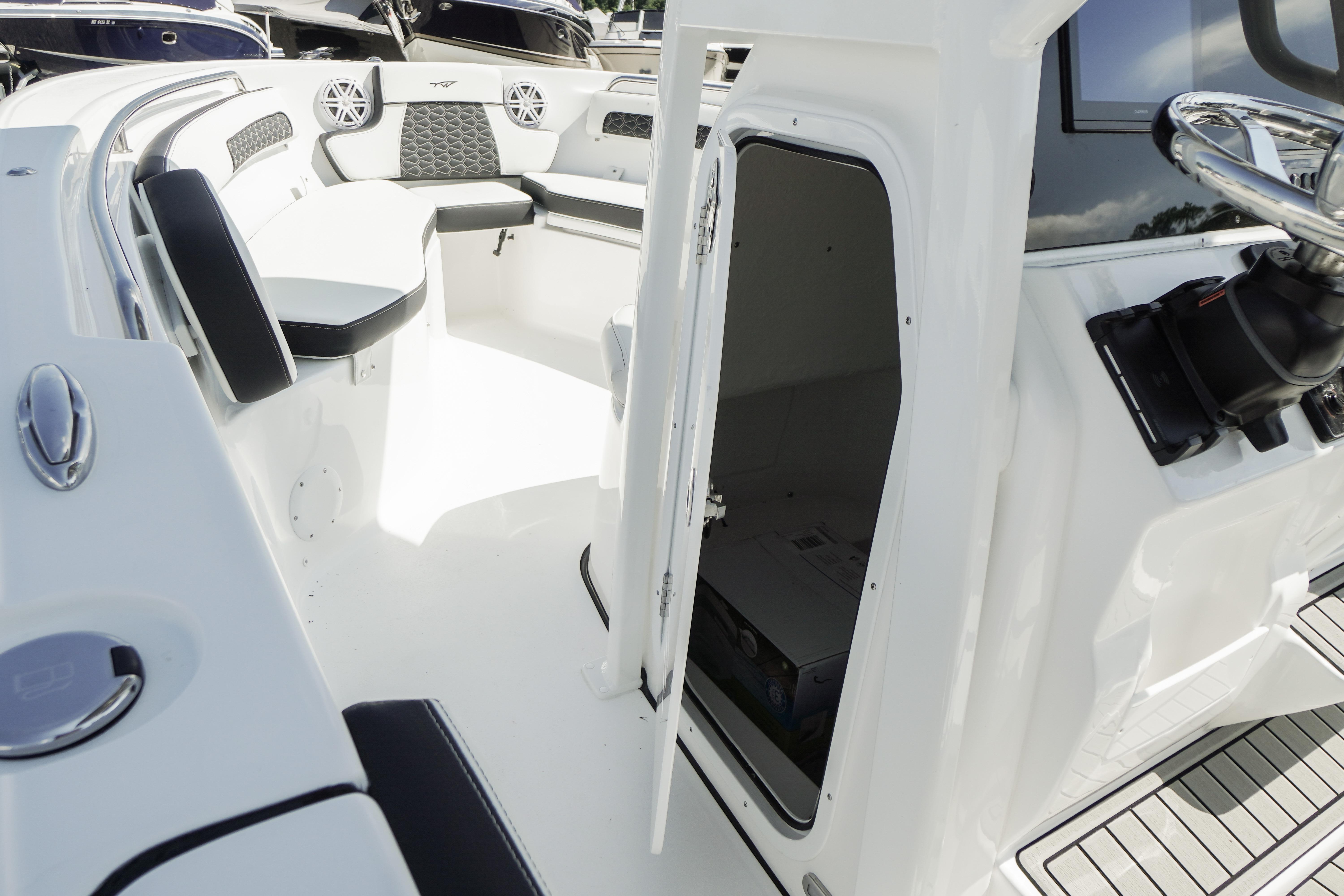2026 Tidewater 220 CC Adventure boat interior with seating and storage compartment.