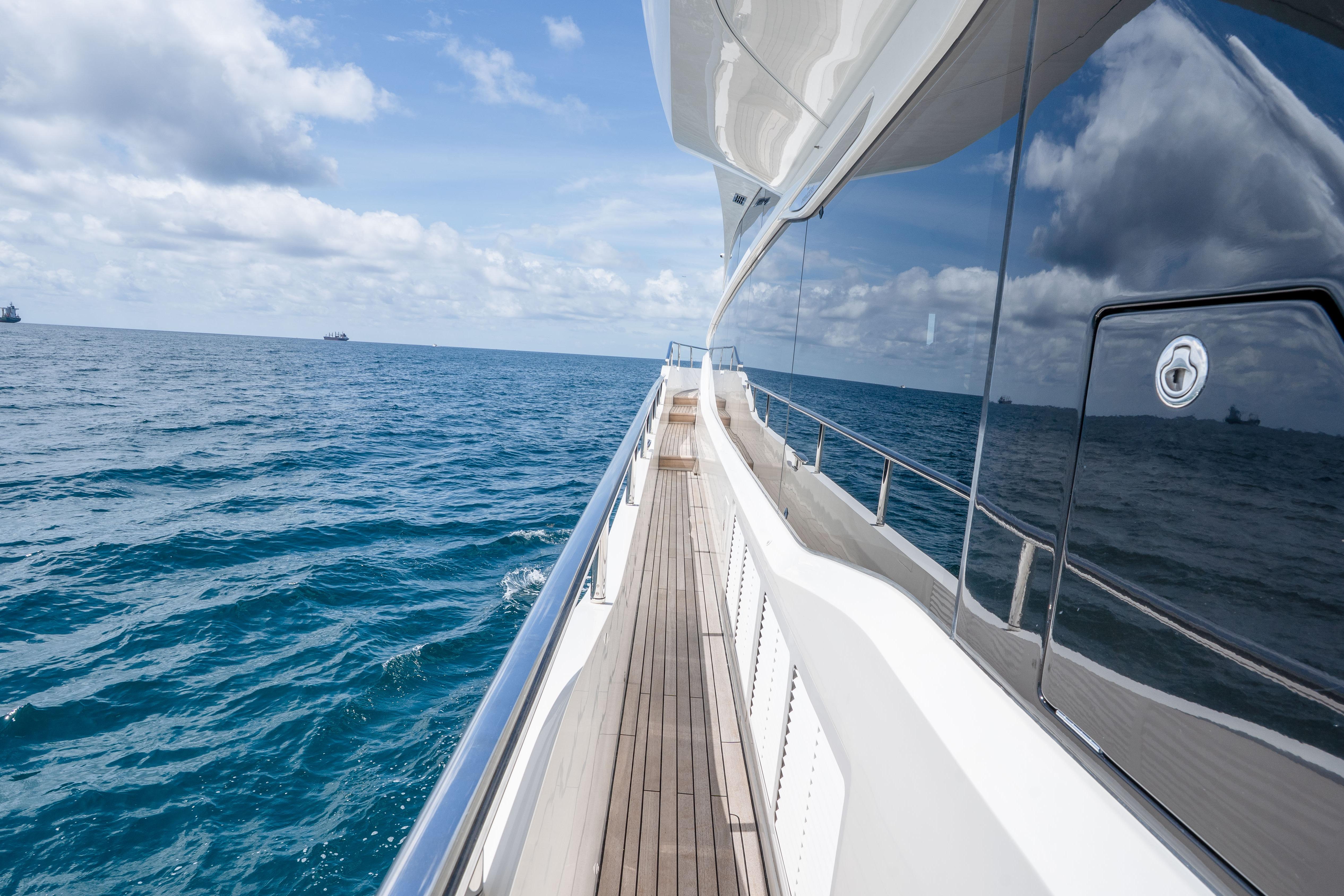 Luxurious 2020 Princess Y85 yacht cruising on open sea under blue skies.