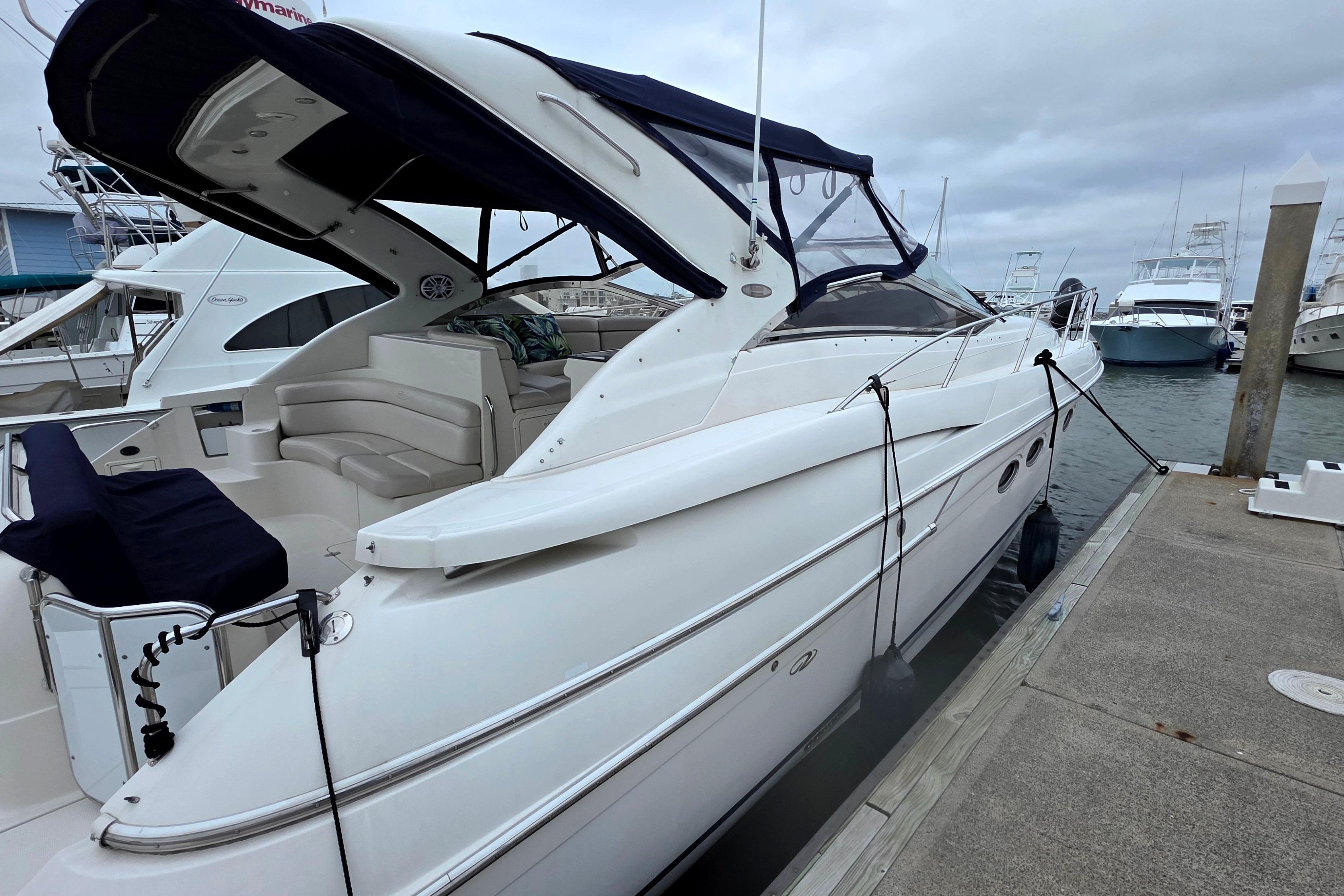 2002 Regal Commodore 4260 yacht docked at marina, featuring sleek design and spacious seating.