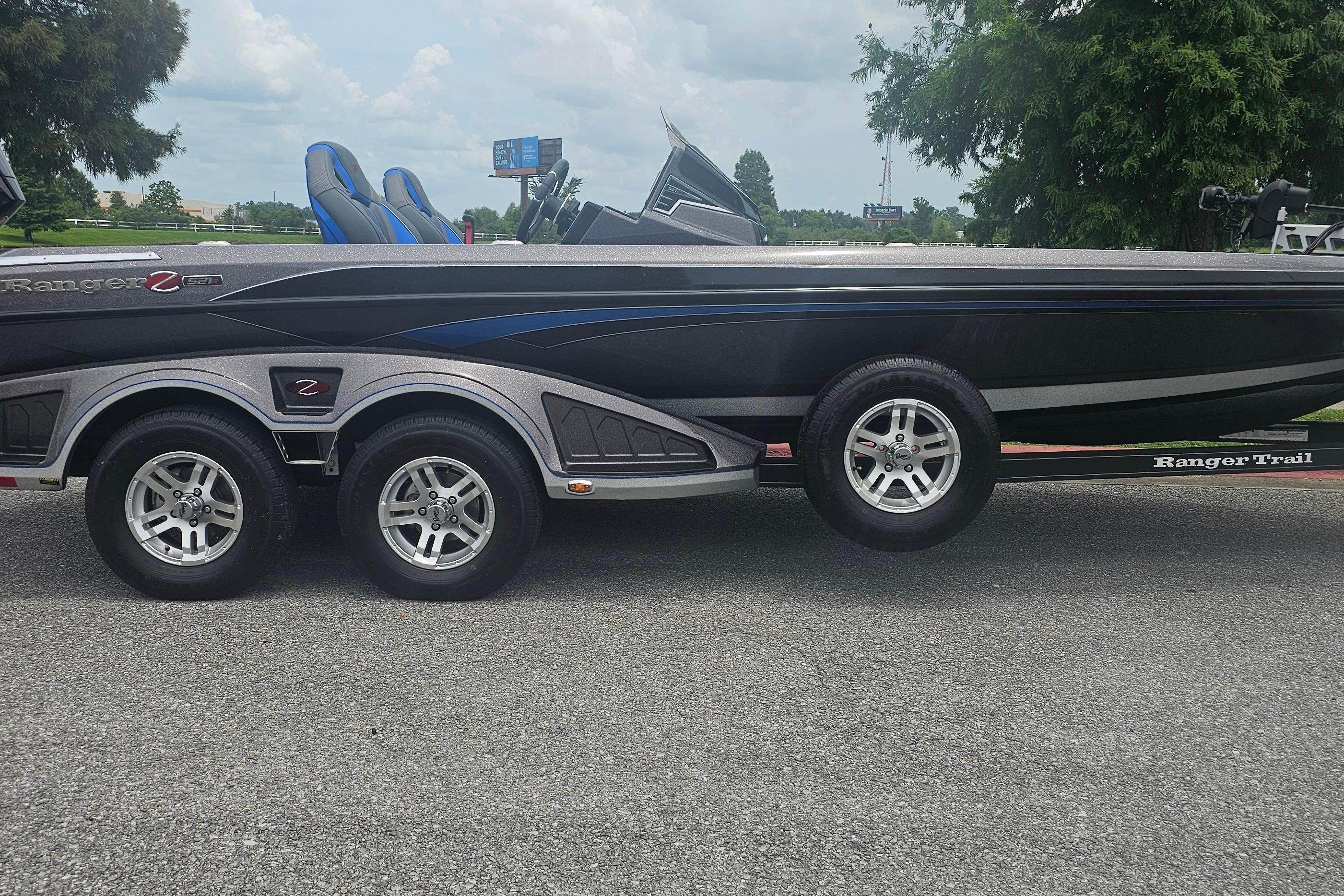 2024 Ranger Z521R boat on trailer, side view, parked on asphalt road.