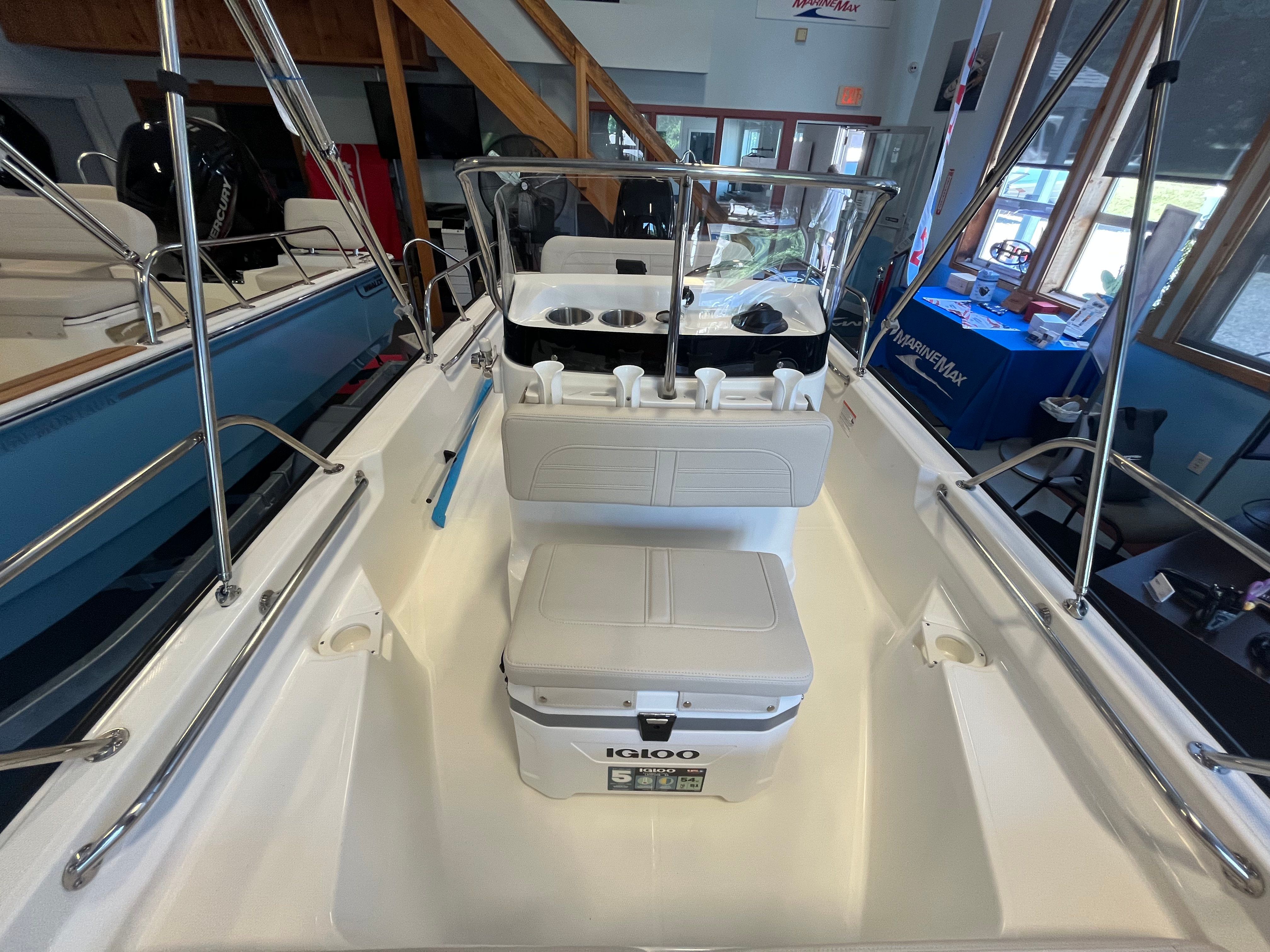 Interior view of a Boston Whaler 150 Montauk with seating and a helm console.