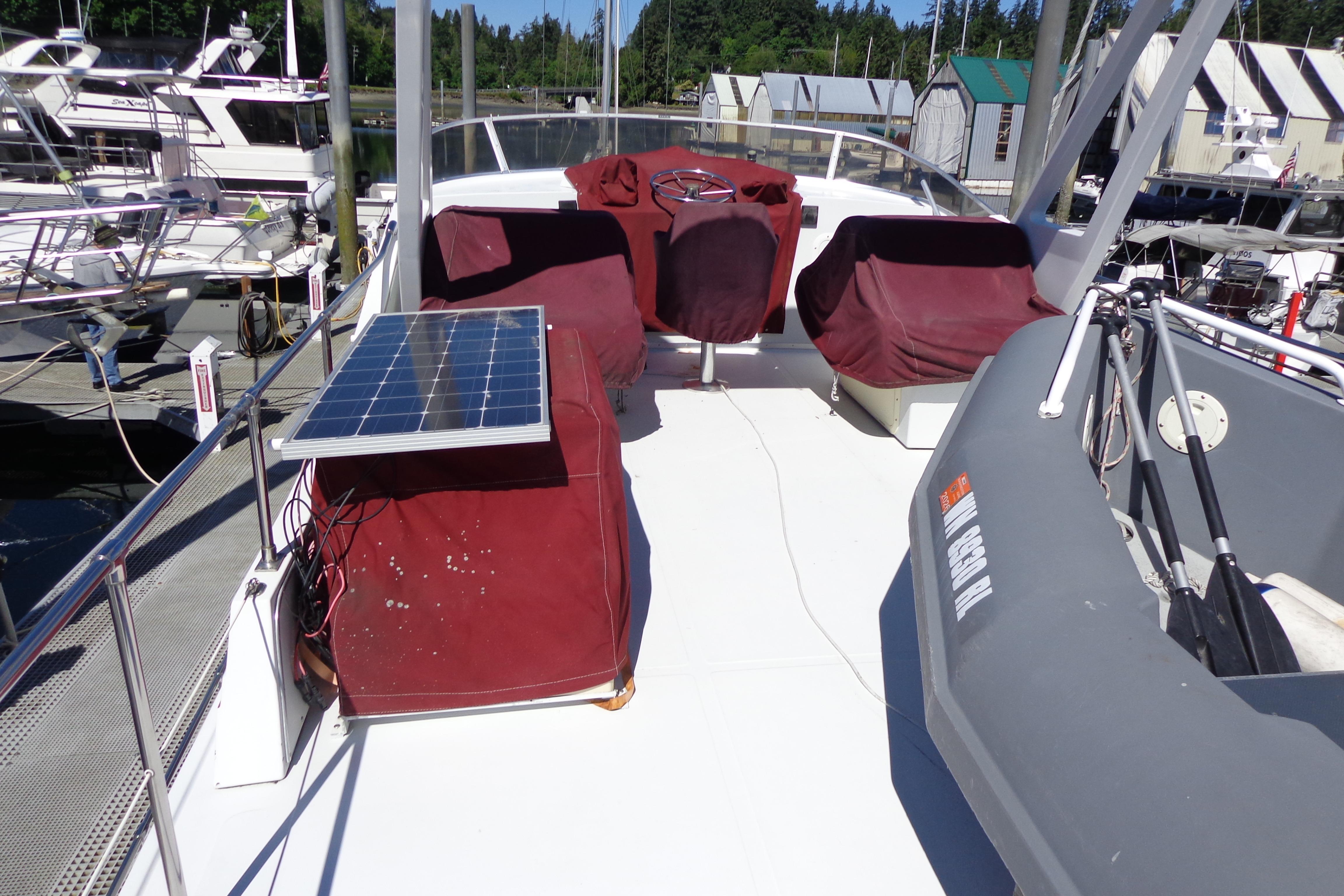 1992 Cruise-A-Home Corsair 4200 boat deck with solar panel and covered seating.