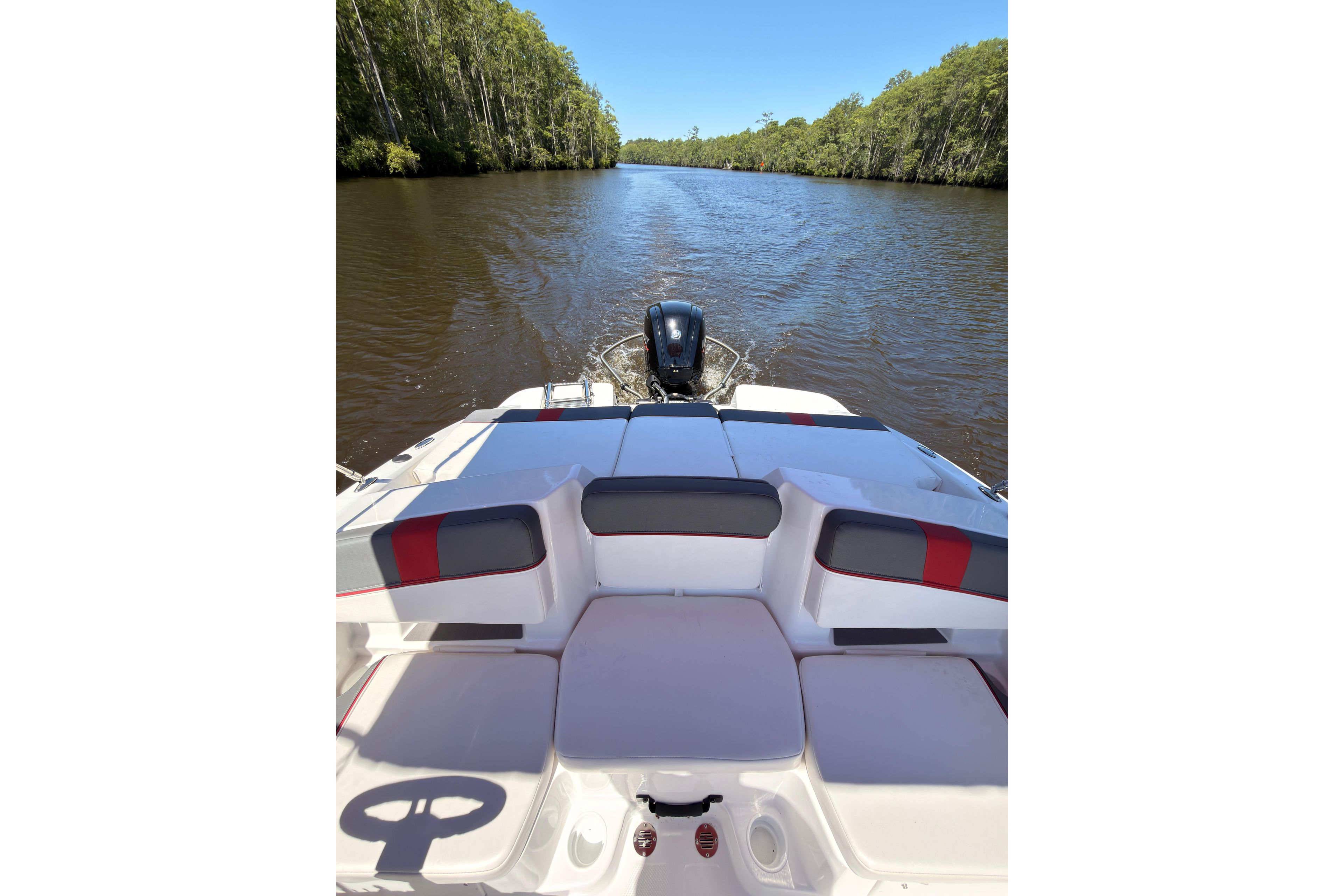 2022 Tahoe T18 boat cruising on a serene river surrounded by lush greenery.