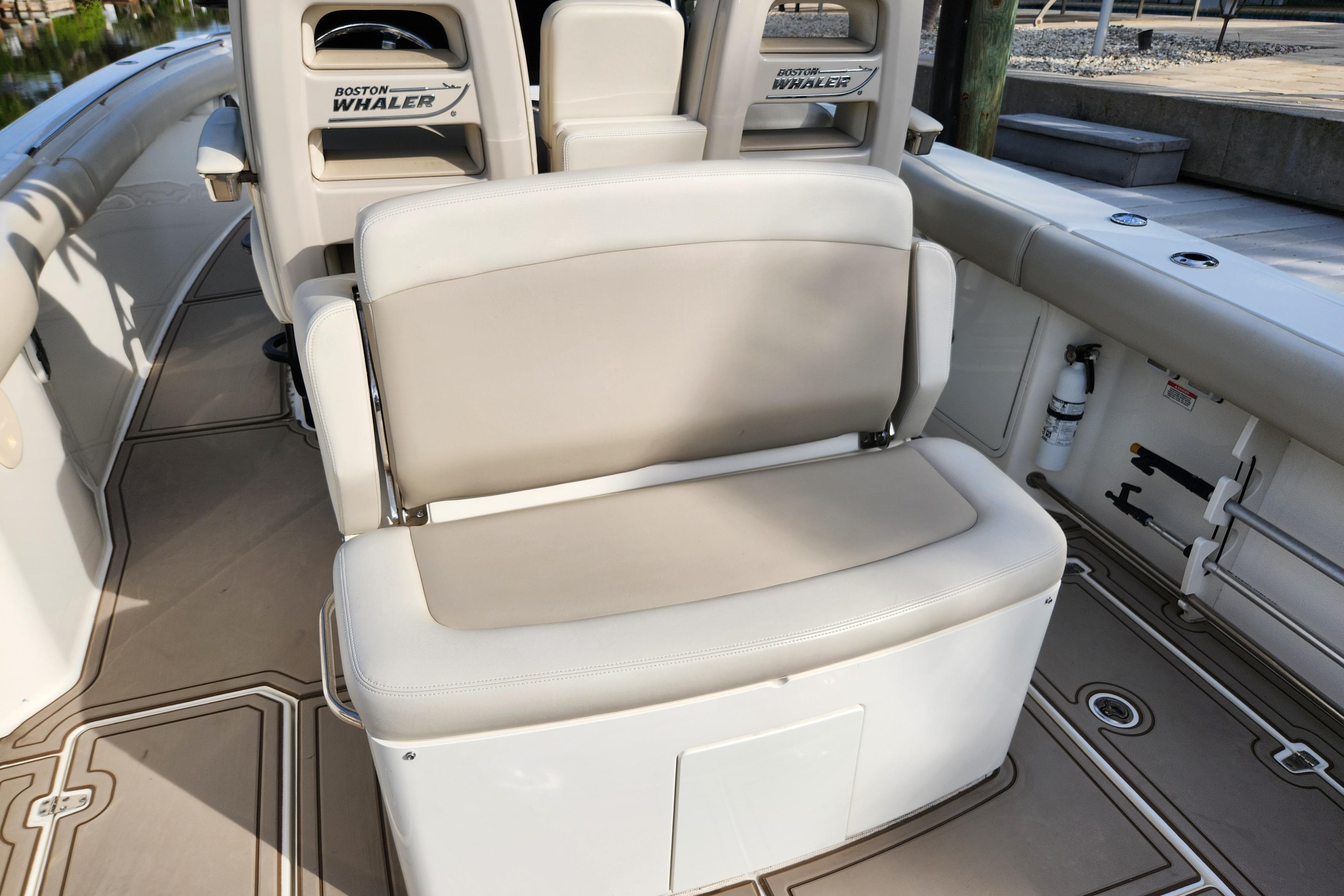 2022 Boston Whaler 330 Outrage boat interior with beige seating and branded backrests.