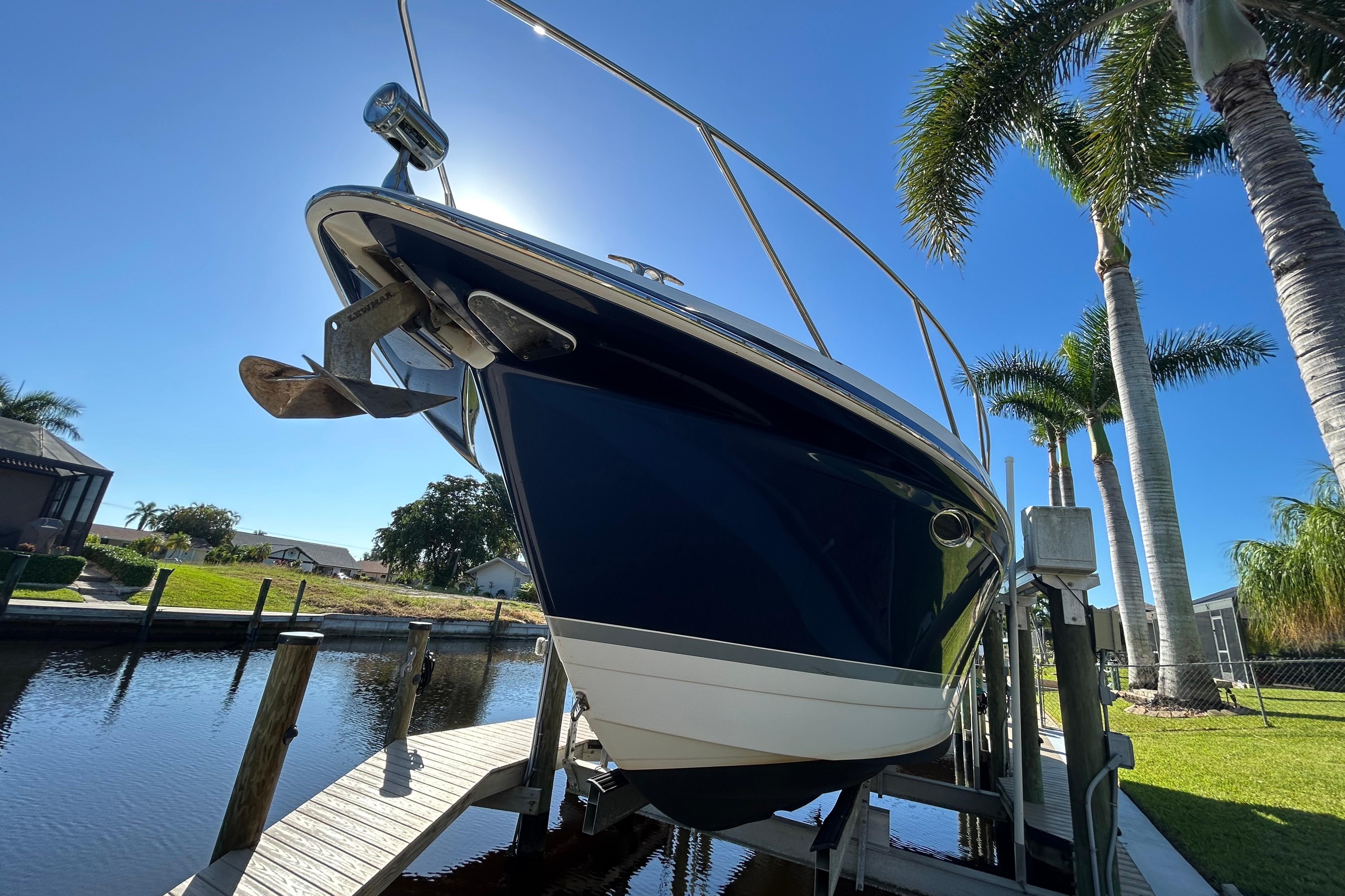 2008 Formula 34 Performance Cruiser on lift, sunny day, palm trees in background.