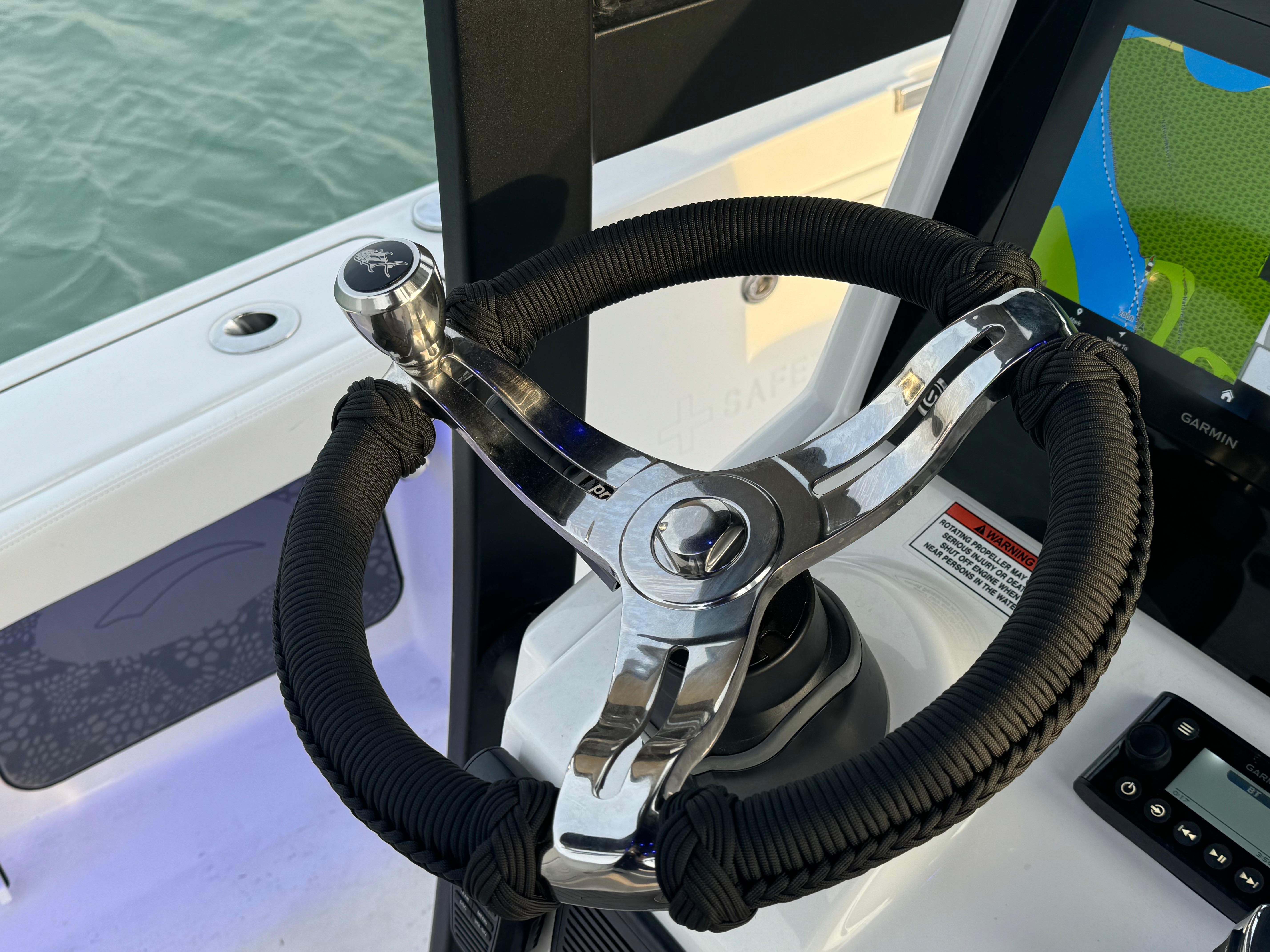 Steering wheel of 2025 Crevalle 24 HCO boat, featuring modern design and controls.