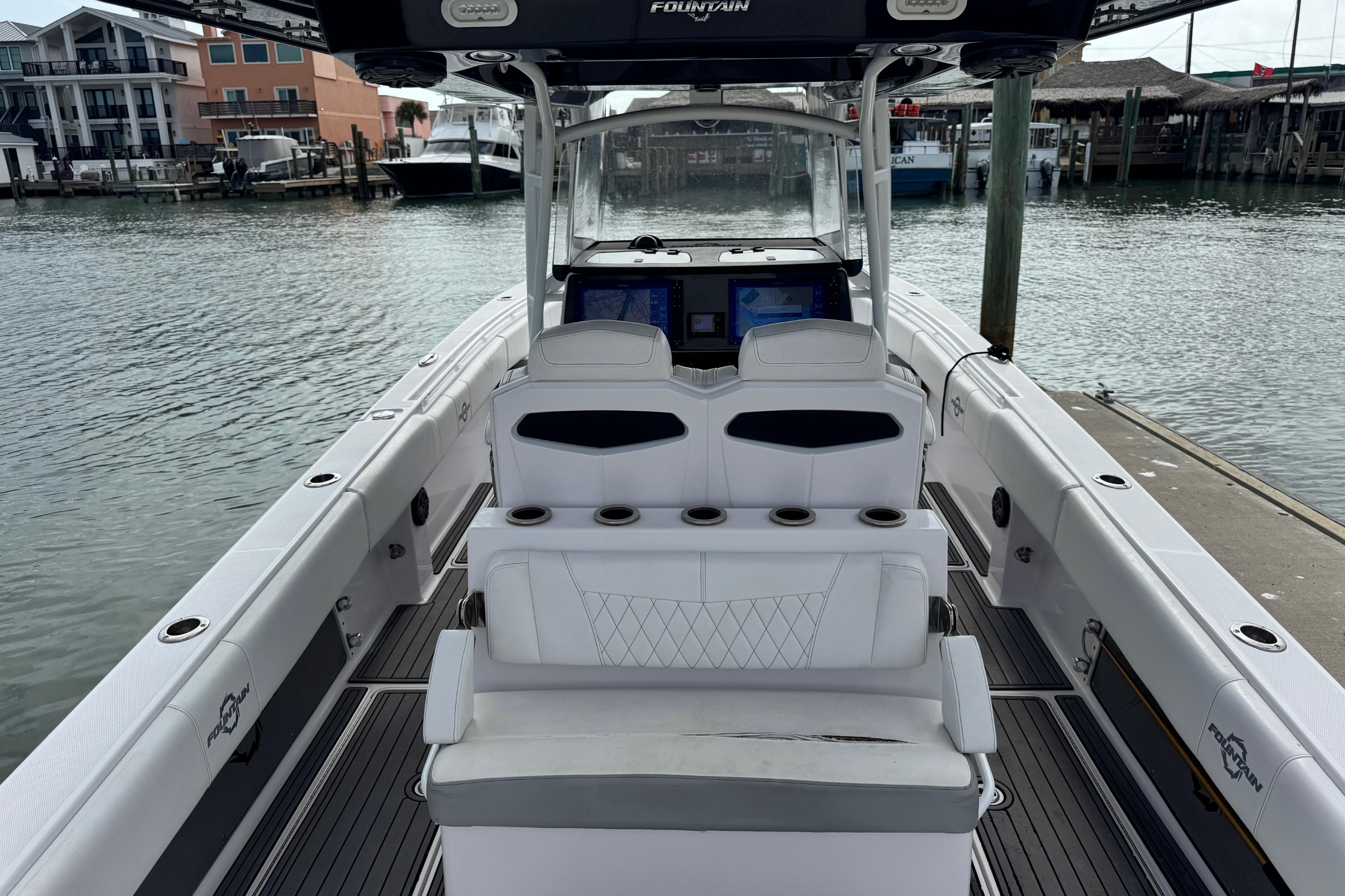 2018 Fountain 34 Center Console boat docked at marina, featuring spacious seating and modern controls.