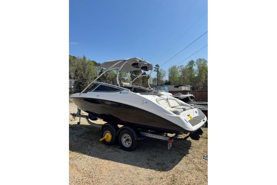 2012 Yamaha AR210 boat on trailer under clear blue sky.