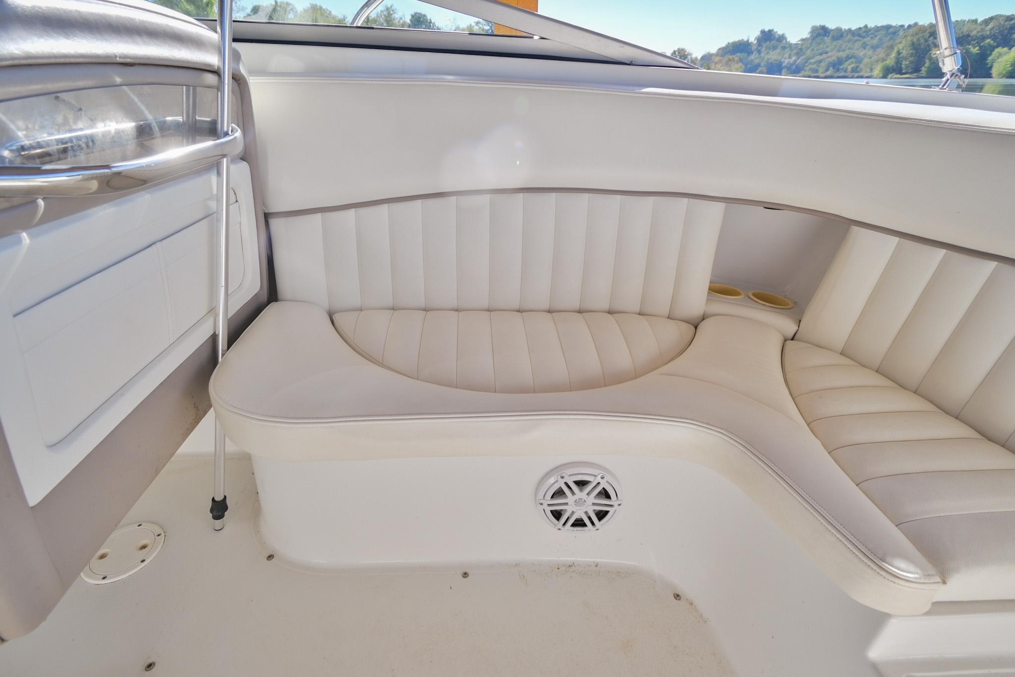 2002 Cobalt 262 boat interior with white cushioned seating and speaker.