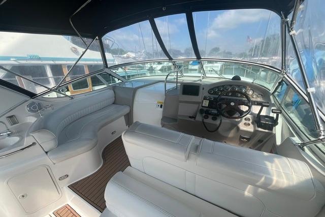 2004 Cruisers Yachts 3372 Express cockpit with white seating and modern dashboard controls.