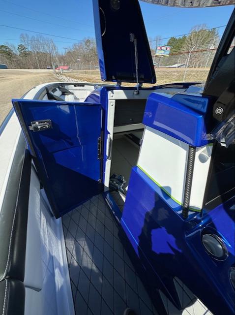 2019 Mystic Powerboats M4200 interior with open blue cabin door, showcasing sleek design.