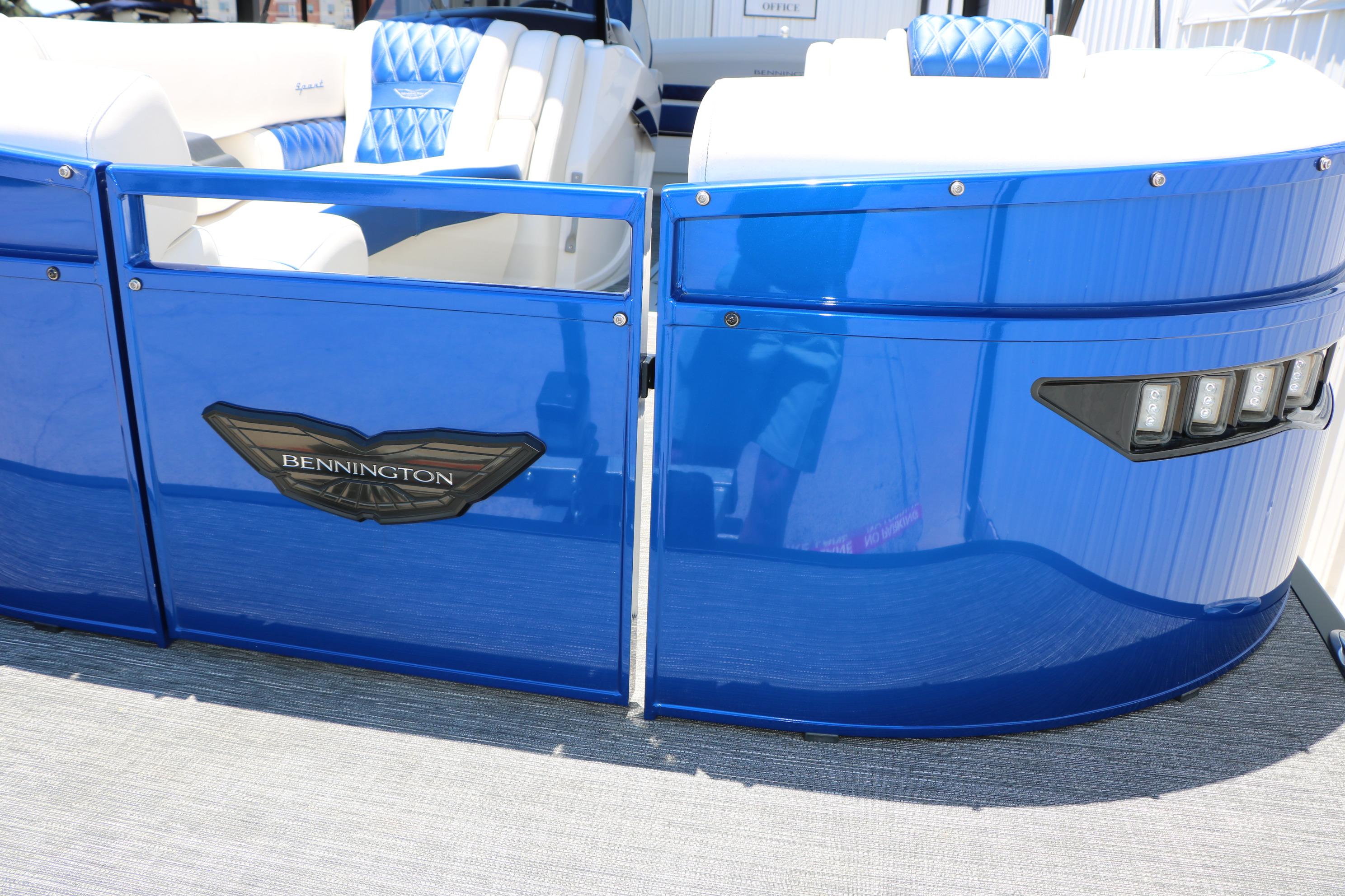 2024 Bennington 23 RX Swingback pontoon boat with blue exterior and luxurious seating.