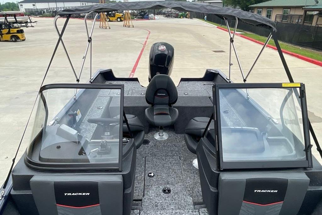 2026 Tracker Pro Guide V-175 Combo boat with dual consoles and canopy in a parking area.