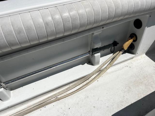 Close-up of a boat cable connection with a cushioned seat above.