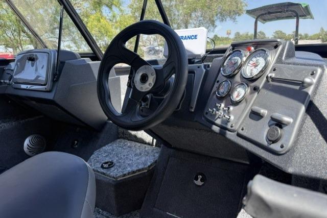 2026 Tracker Pro Guide V-175 WT boat dashboard with steering wheel and instrument panel.