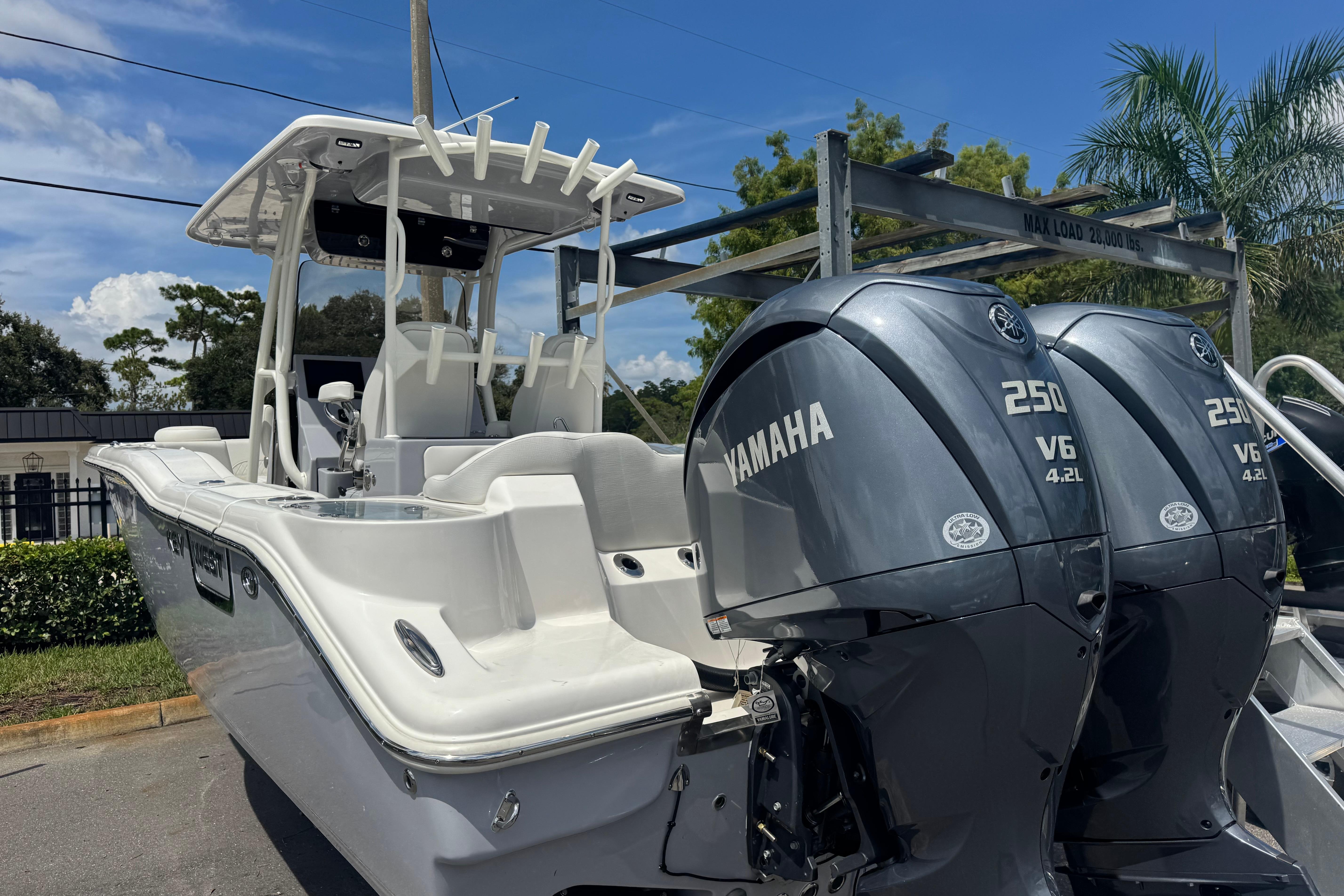 2025 Key West 263 FS boat with dual Yamaha 250 V6 engines, parked outdoors.