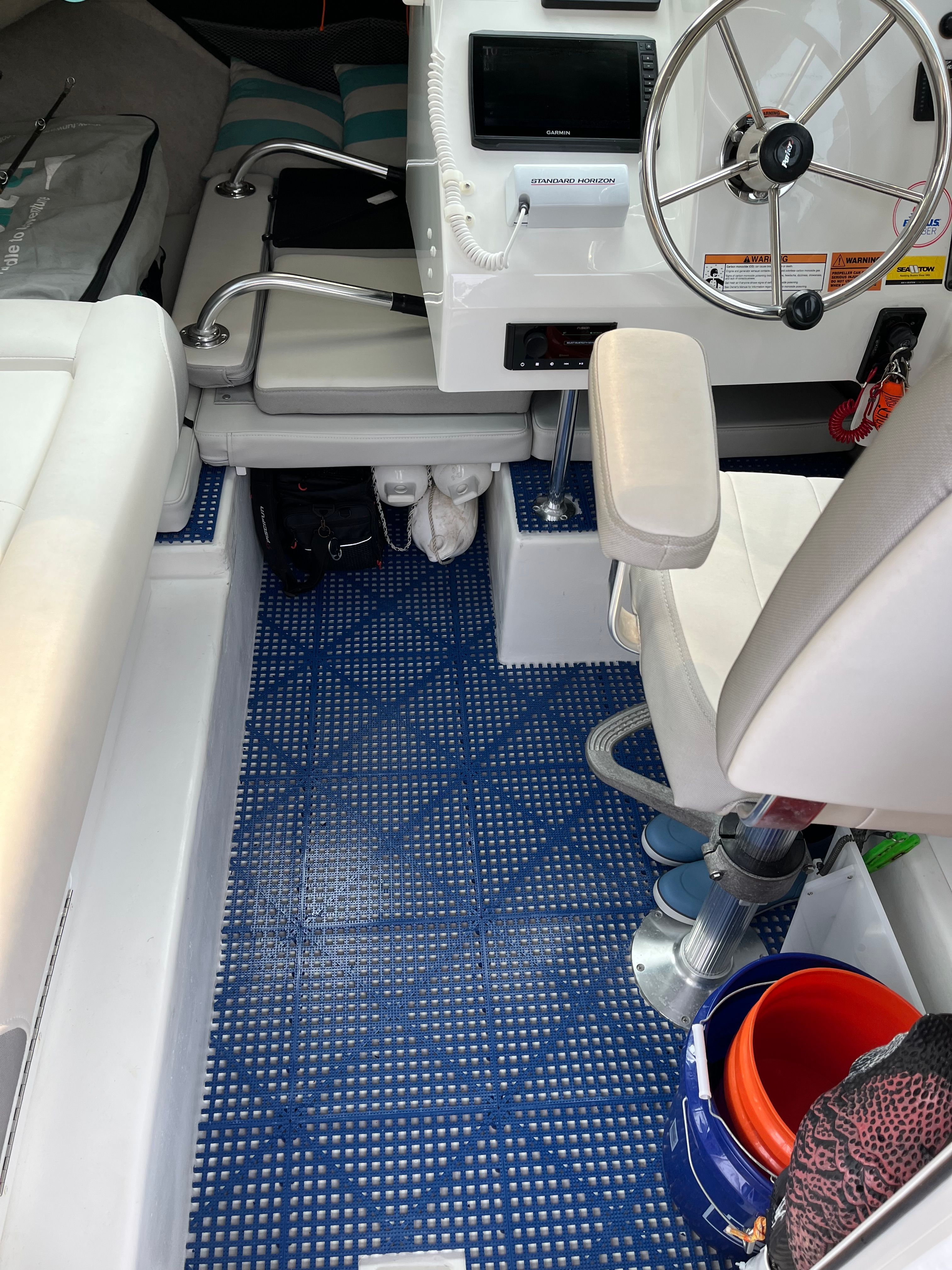 Interior of a Parker 2021 sport cabin with blue flooring and a steering wheel.