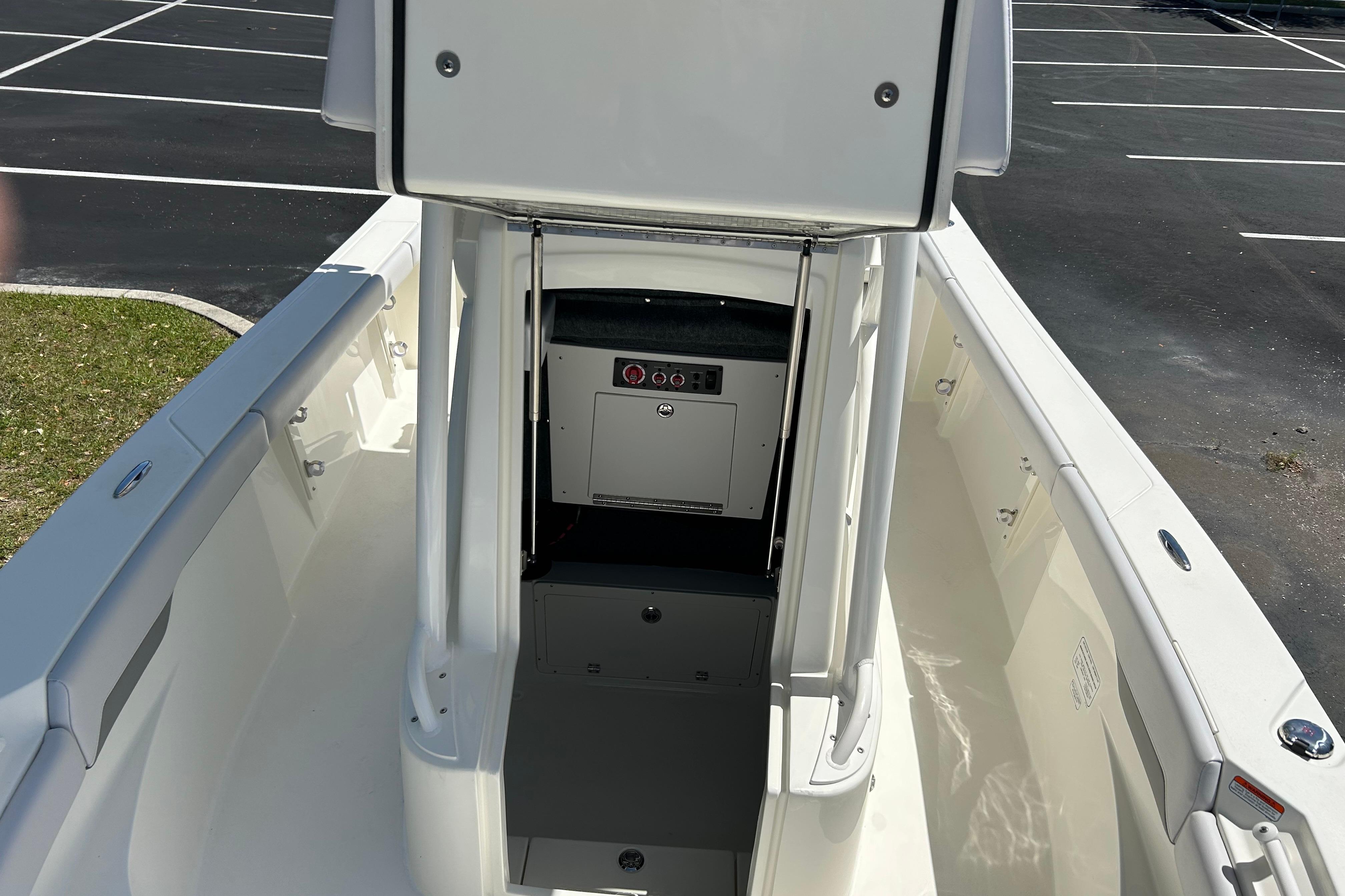 2026 Mako 226 Center Console boat interior with storage compartment, parked in a lot.