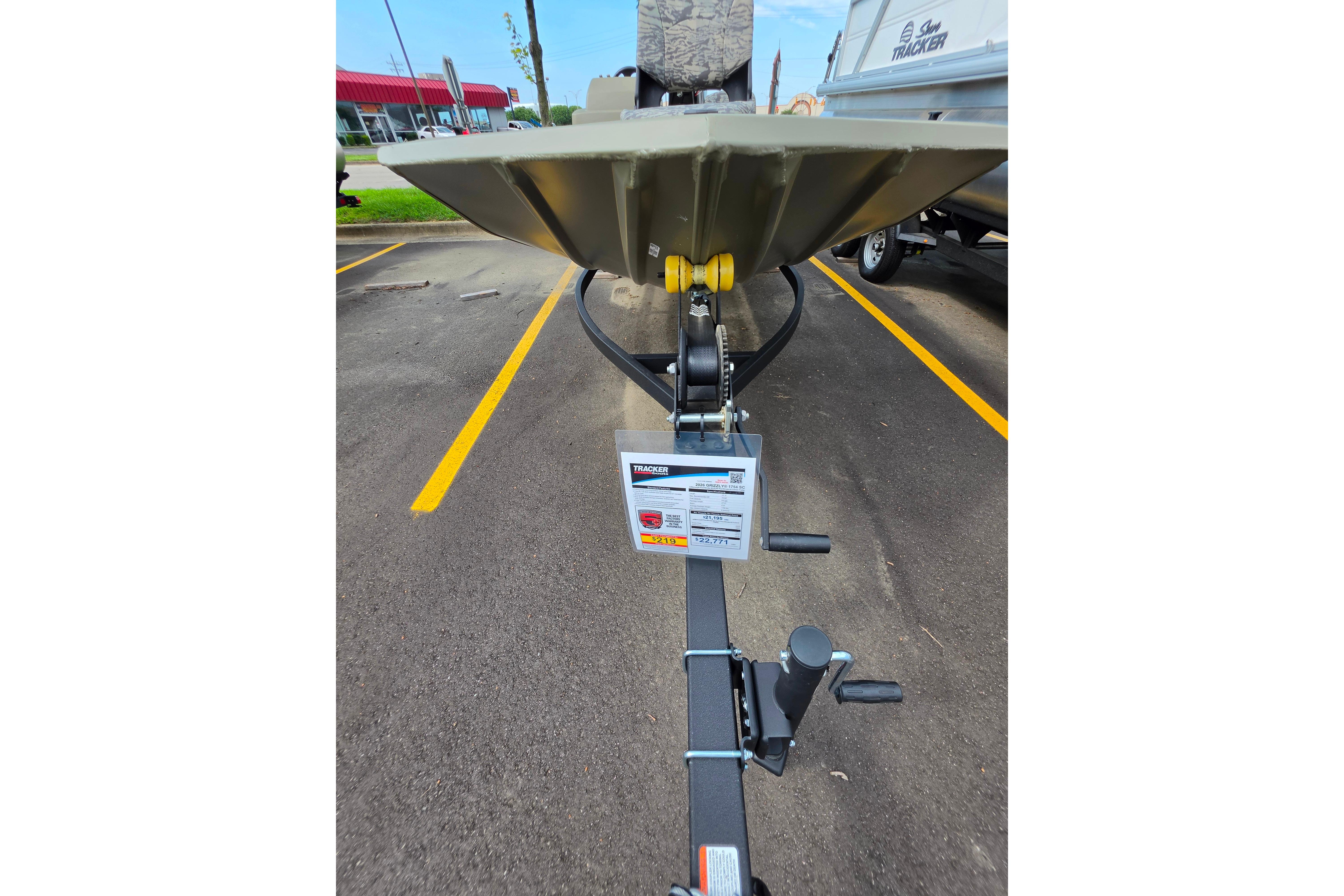 2026 Tracker Grizzly 1754 SC boat on trailer in parking lot.