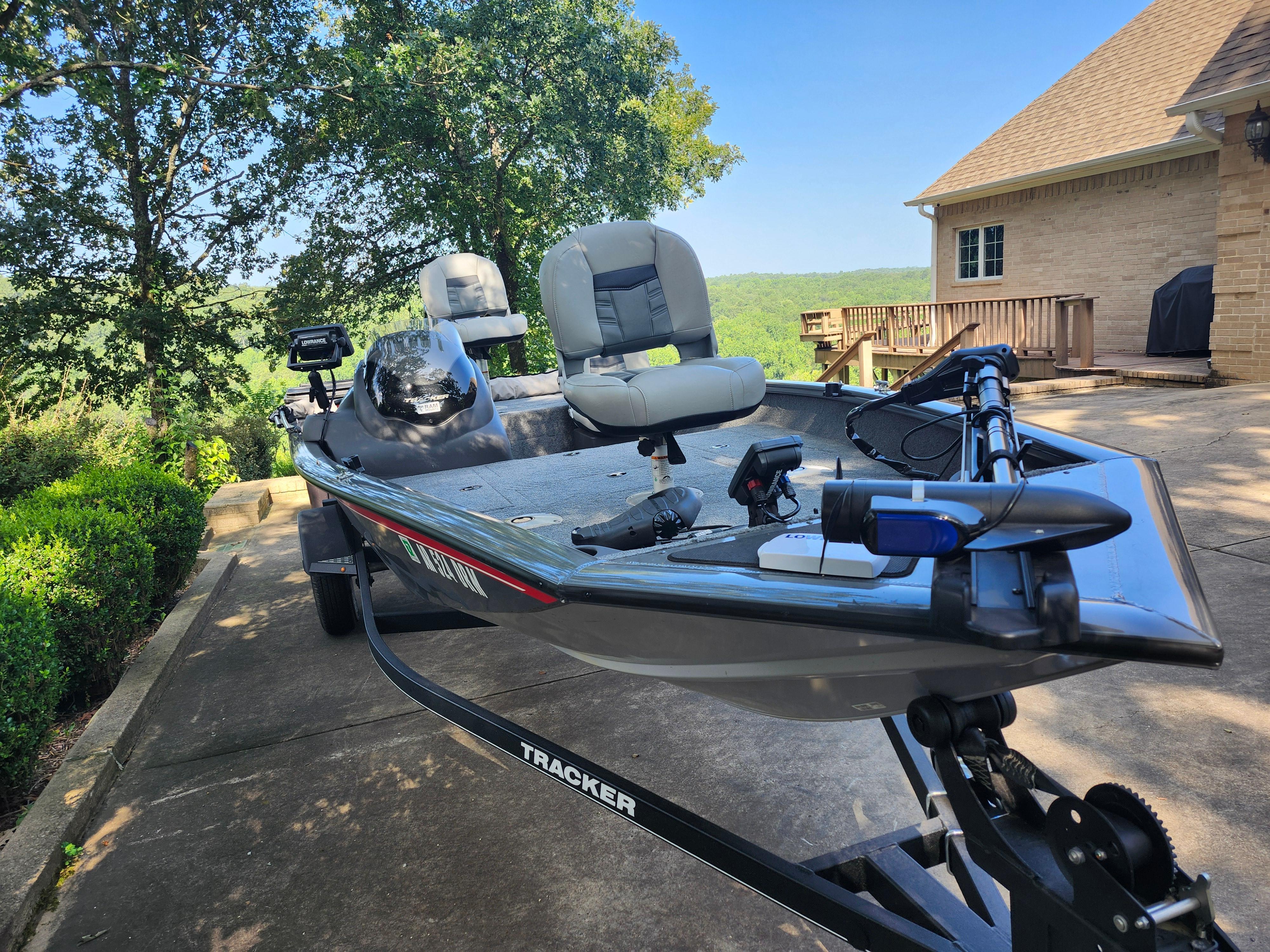 2018 Tracker Pro 175 TF boat on trailer, parked in driveway with scenic background.