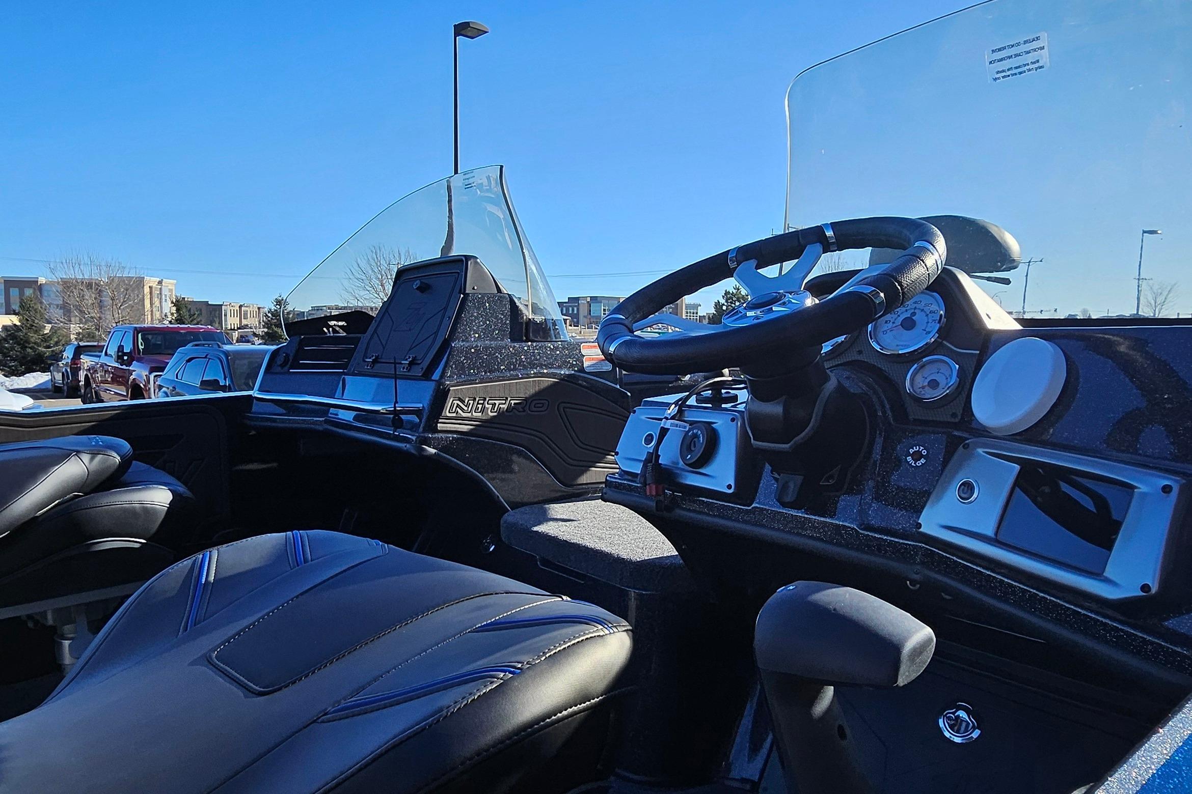 Interior view of 2025 Nitro ZV20 boat cockpit with steering wheel and dashboard.