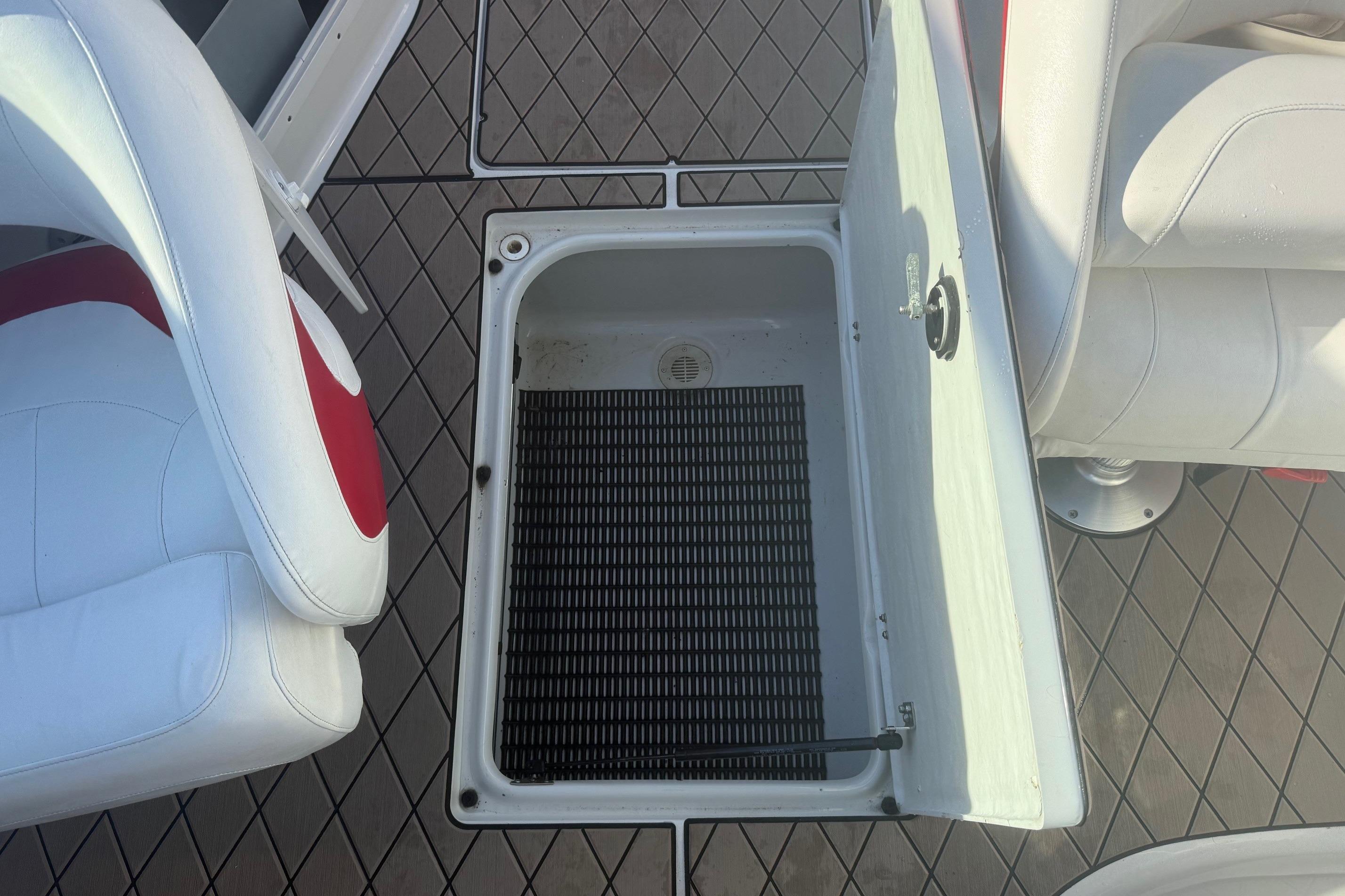 Open storage compartment on 2005 Crownline 270 BR boat deck with seating.