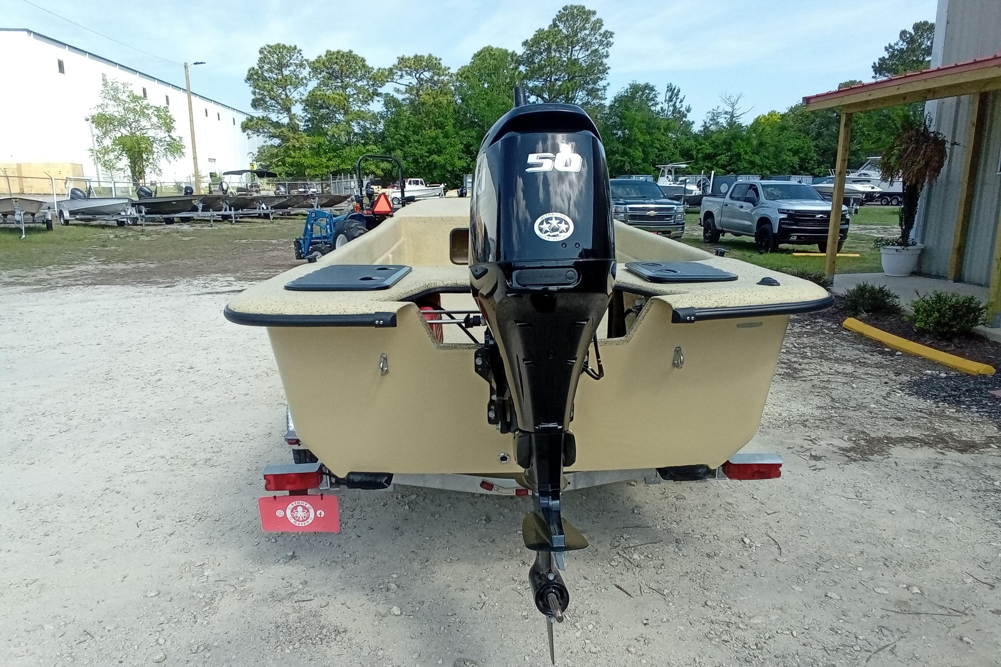 2025 Fibercraft F17 boat with 50HP outboard motor, parked outdoors.