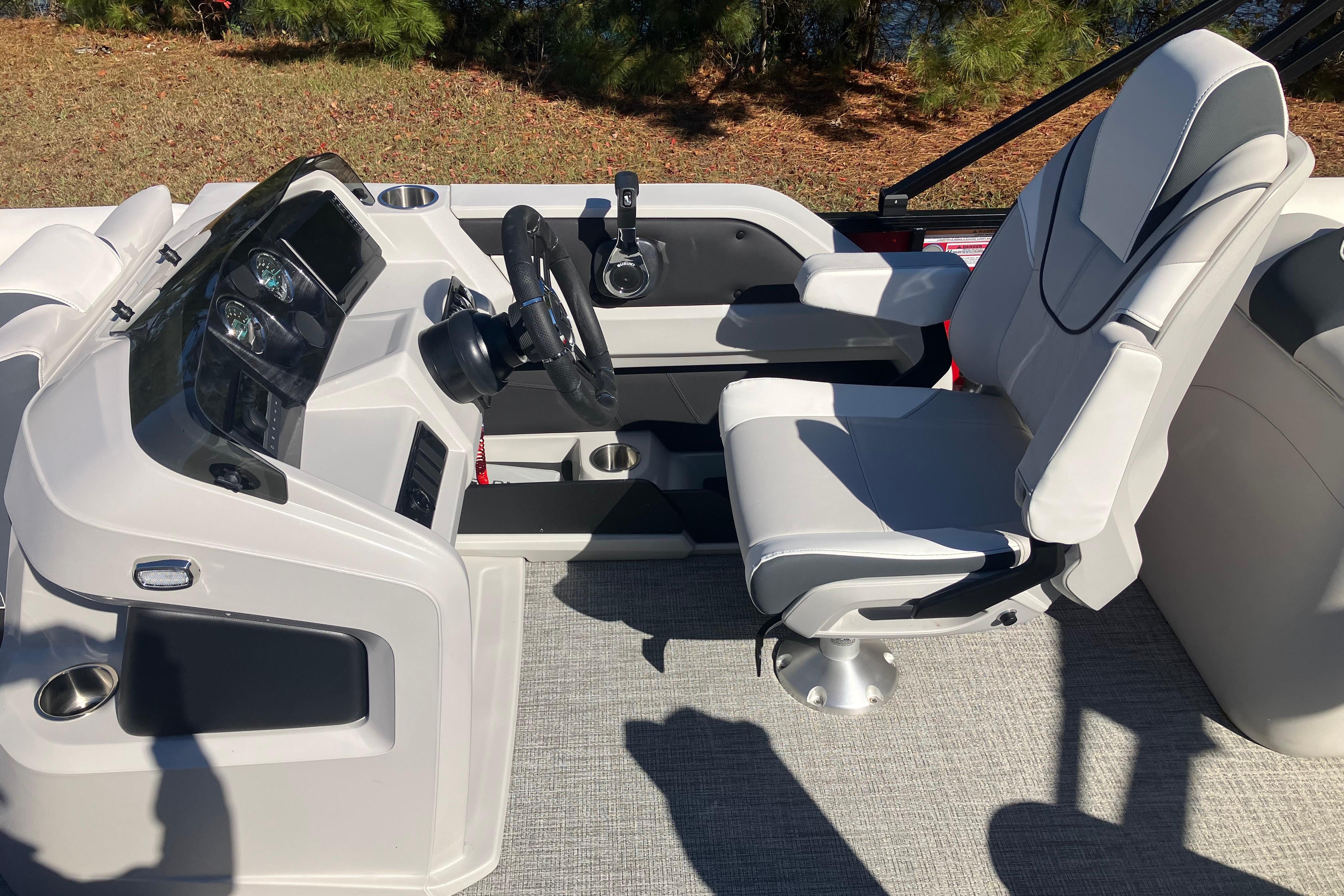 2026 Tahoe Pontoon LTZ Quad Lounger helm with modern steering and comfortable seating.