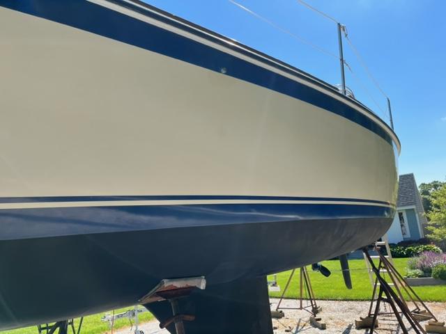 1979 O'Day 28 sailboat on stands, blue and white hull, sunny day.