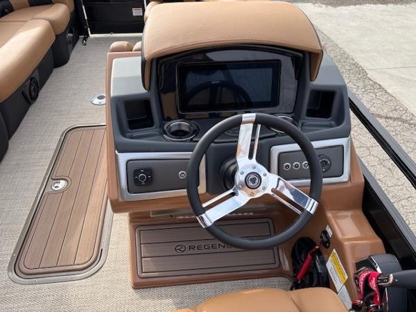 2025 Regency 230 LE3 boat dashboard with steering wheel and control panel.