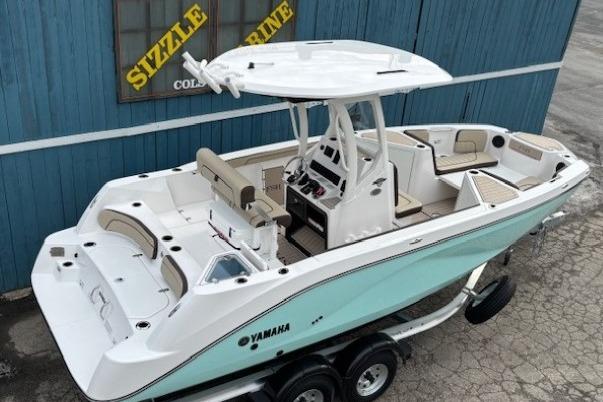 2026 Yamaha Boats 222 FSH Sport E, sleek design, dual console, on trailer, blue and white exterior.