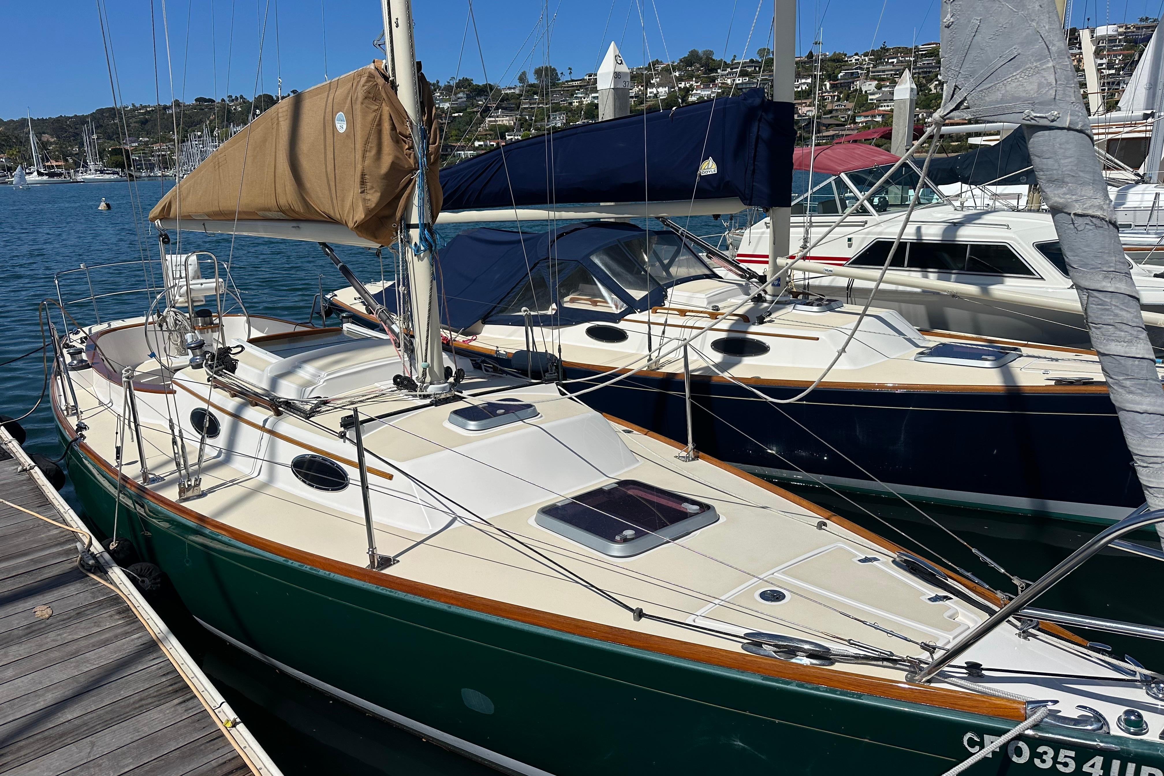 Sailboat Alerion Sport 33, 2011 model, docked at marina with scenic background.