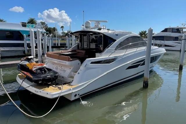 2016 Sea Ray Sundancer 510 yacht docked with jet ski on platform.