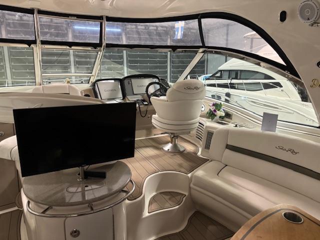 Luxurious 2008 Sea Ray 52 Sundancer yacht interior with helm, seating, and TV.