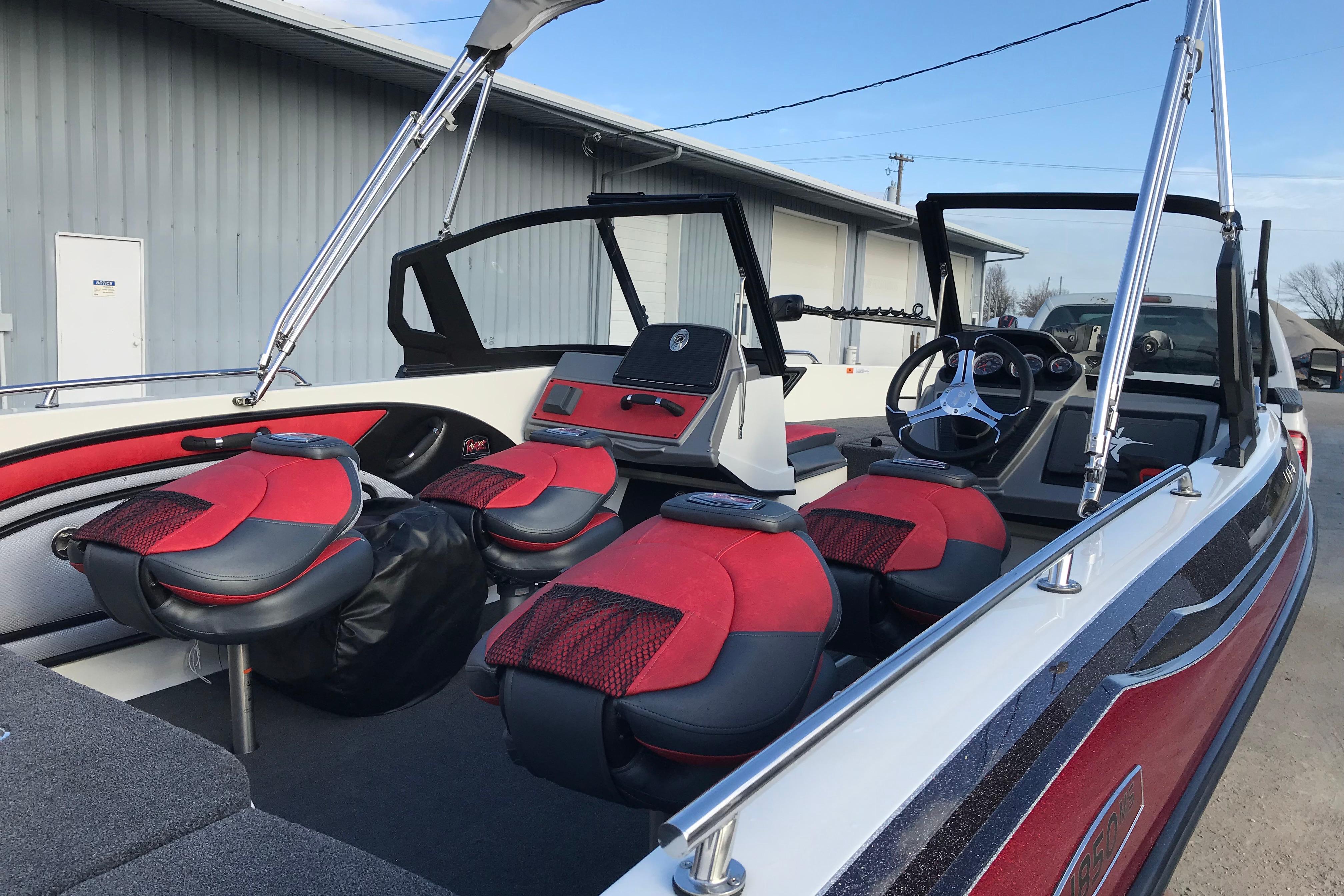 2026 Ranger 1850MS boat interior with red and black seating, modern dashboard, and steering wheel.