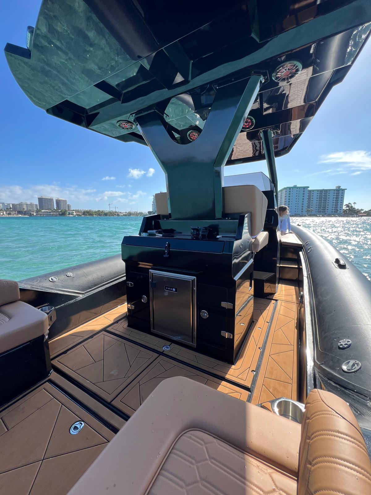 Luxury Novielli Veloche 349 boat interior, 2026 model, on clear blue water with city skyline.