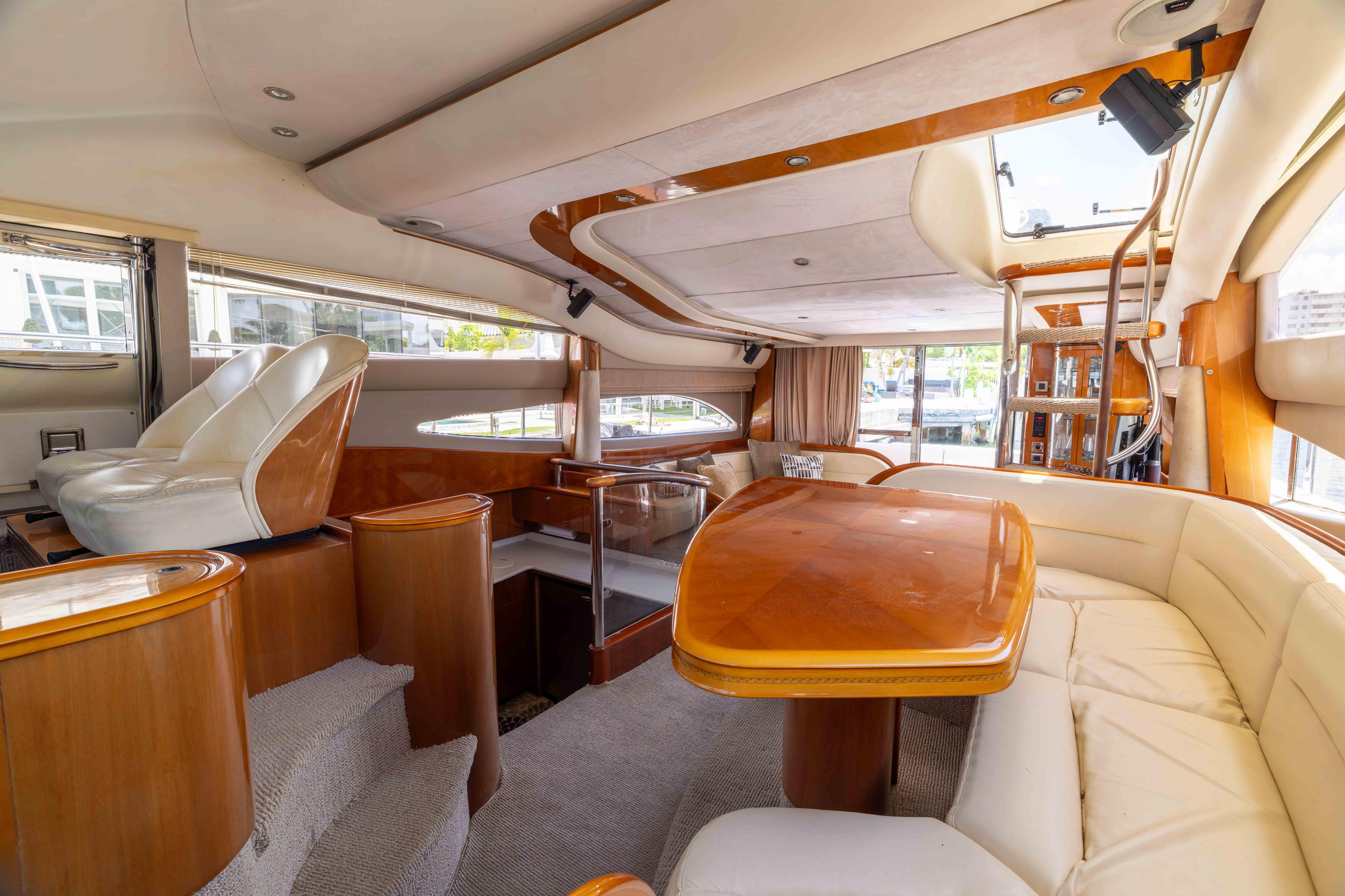 Luxurious interior of a 2002 Princess 61 yacht with elegant seating and wooden finishes.