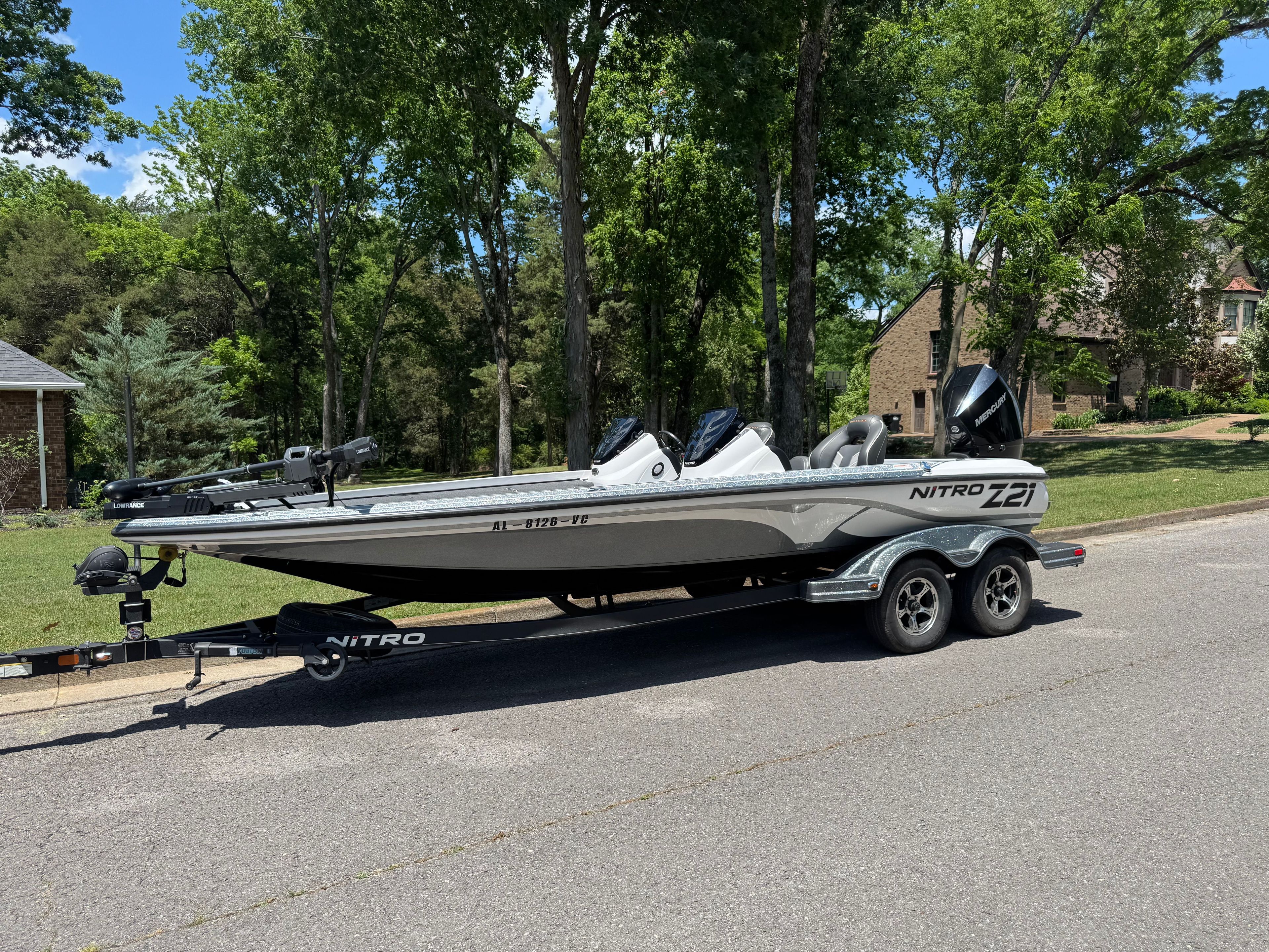 2019 Nitro Z21 boat on trailer, parked on street.