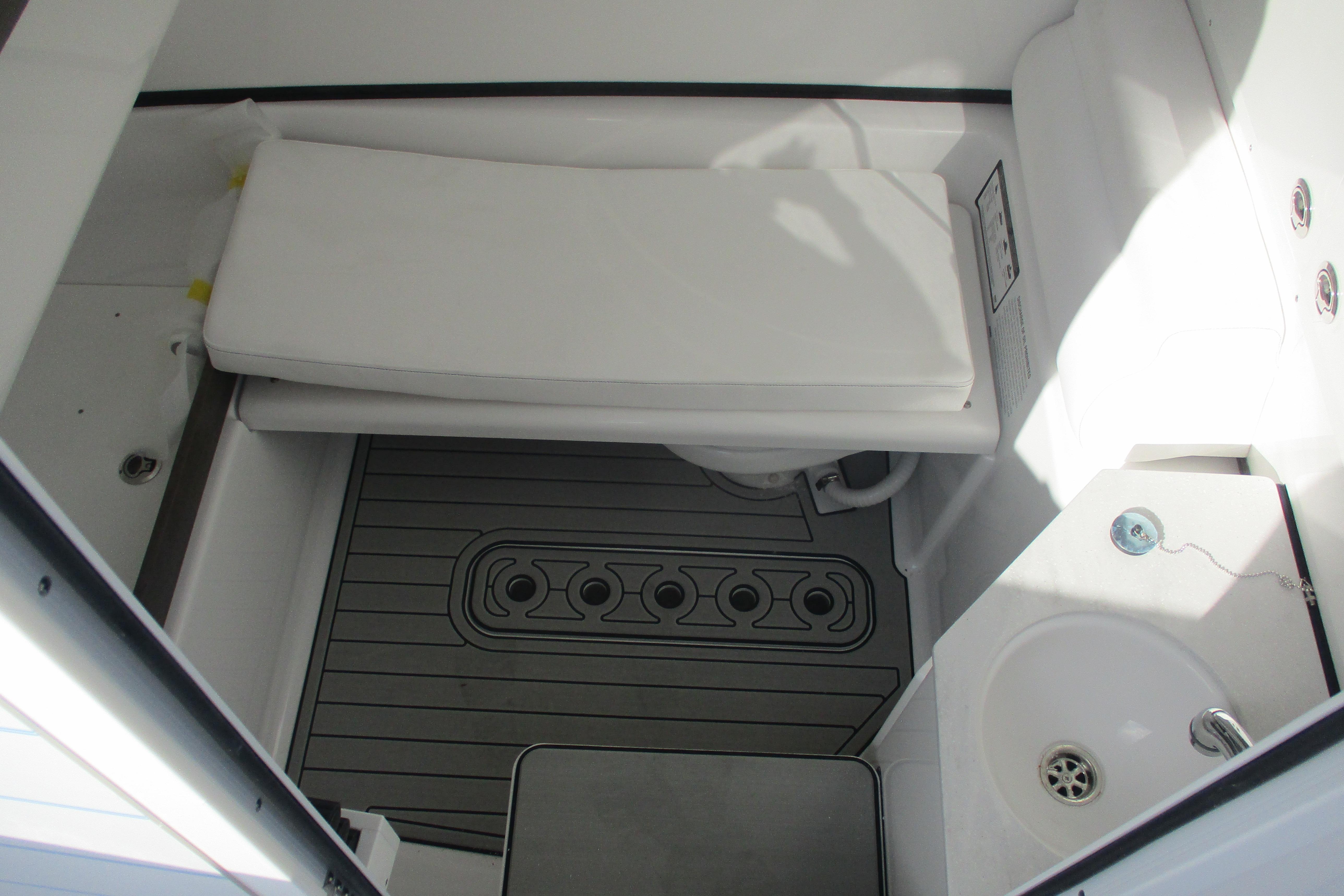 2026 Sportsman Open 302 Center Console interior with cushioned seating and compact sink.