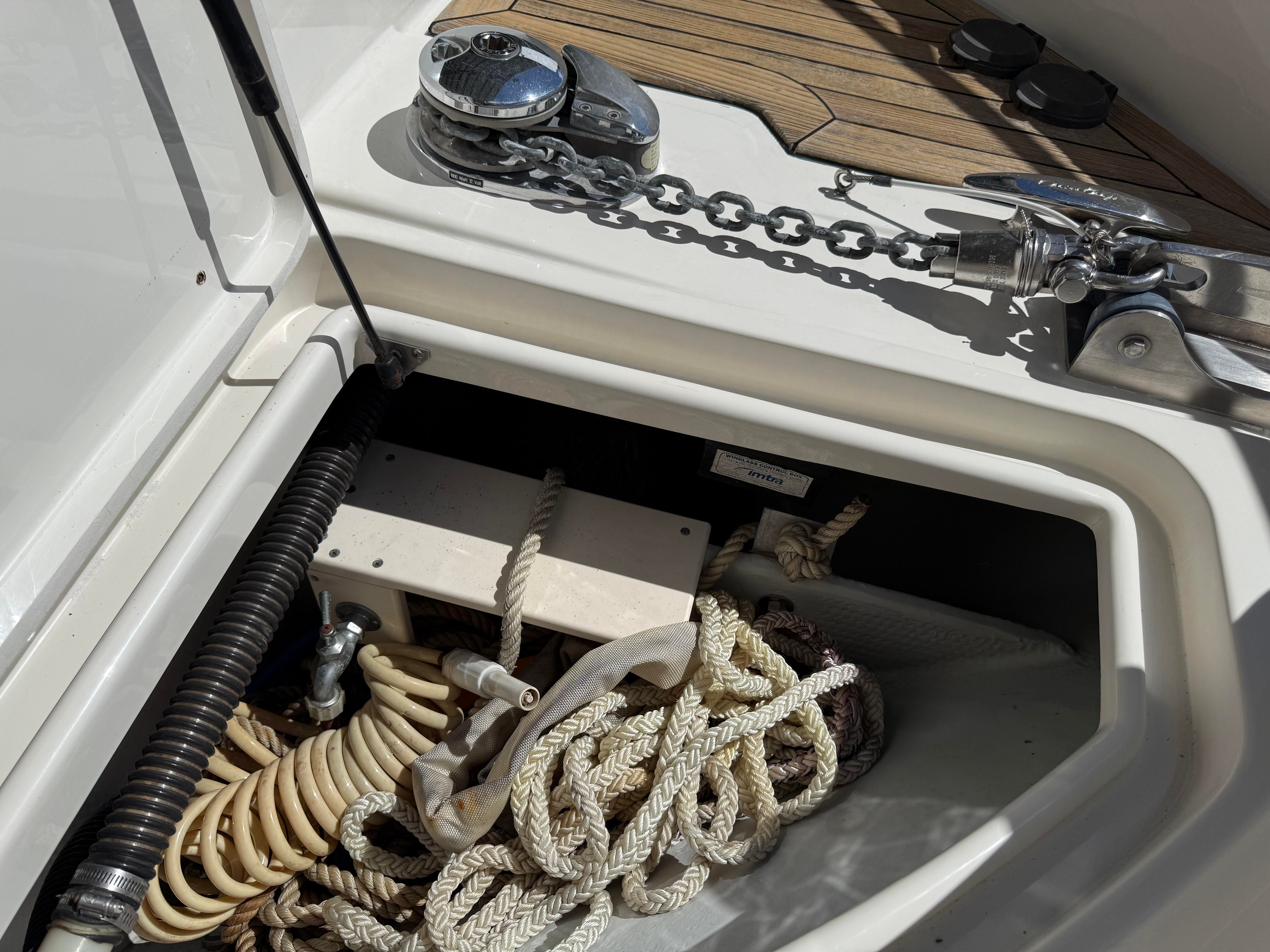 Close-up of an anchor locker with ropes and chains on a Chris-Craft Roamer 40 boat.