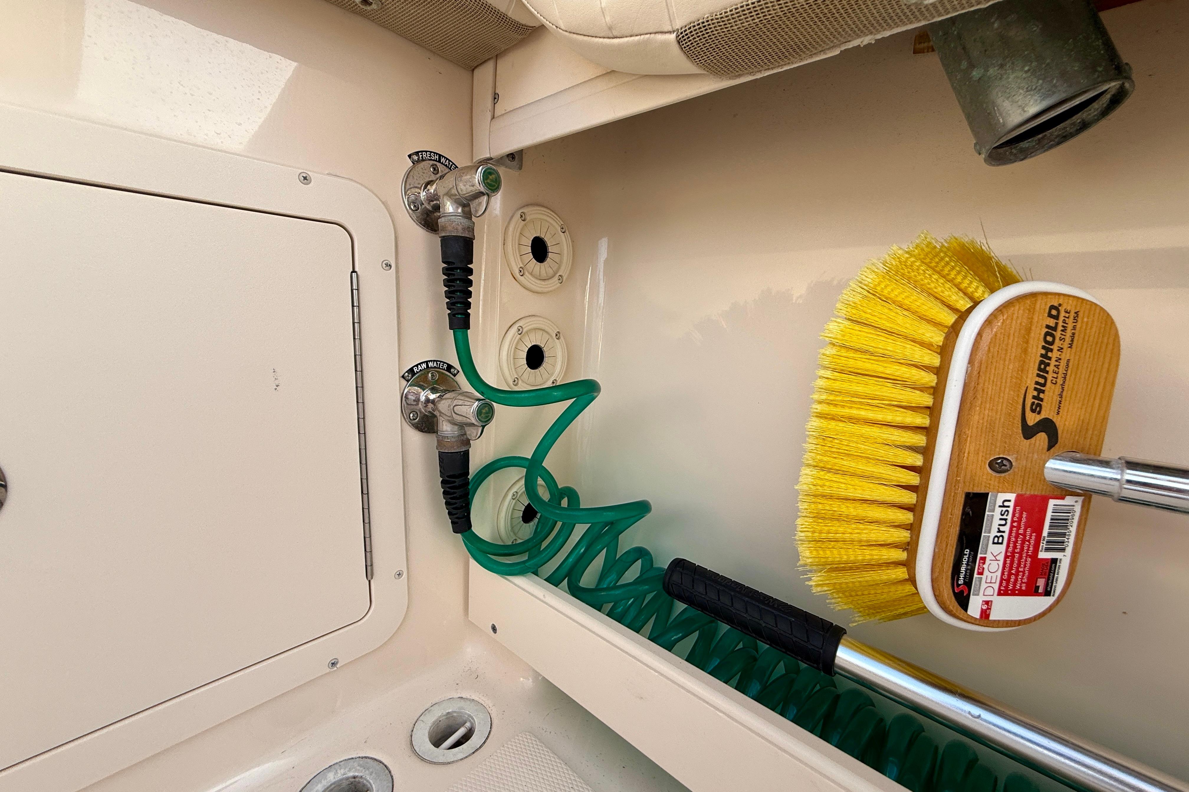 2012 Grady-White Canyon 336 boat deck with hose and Shurhold deck brush.