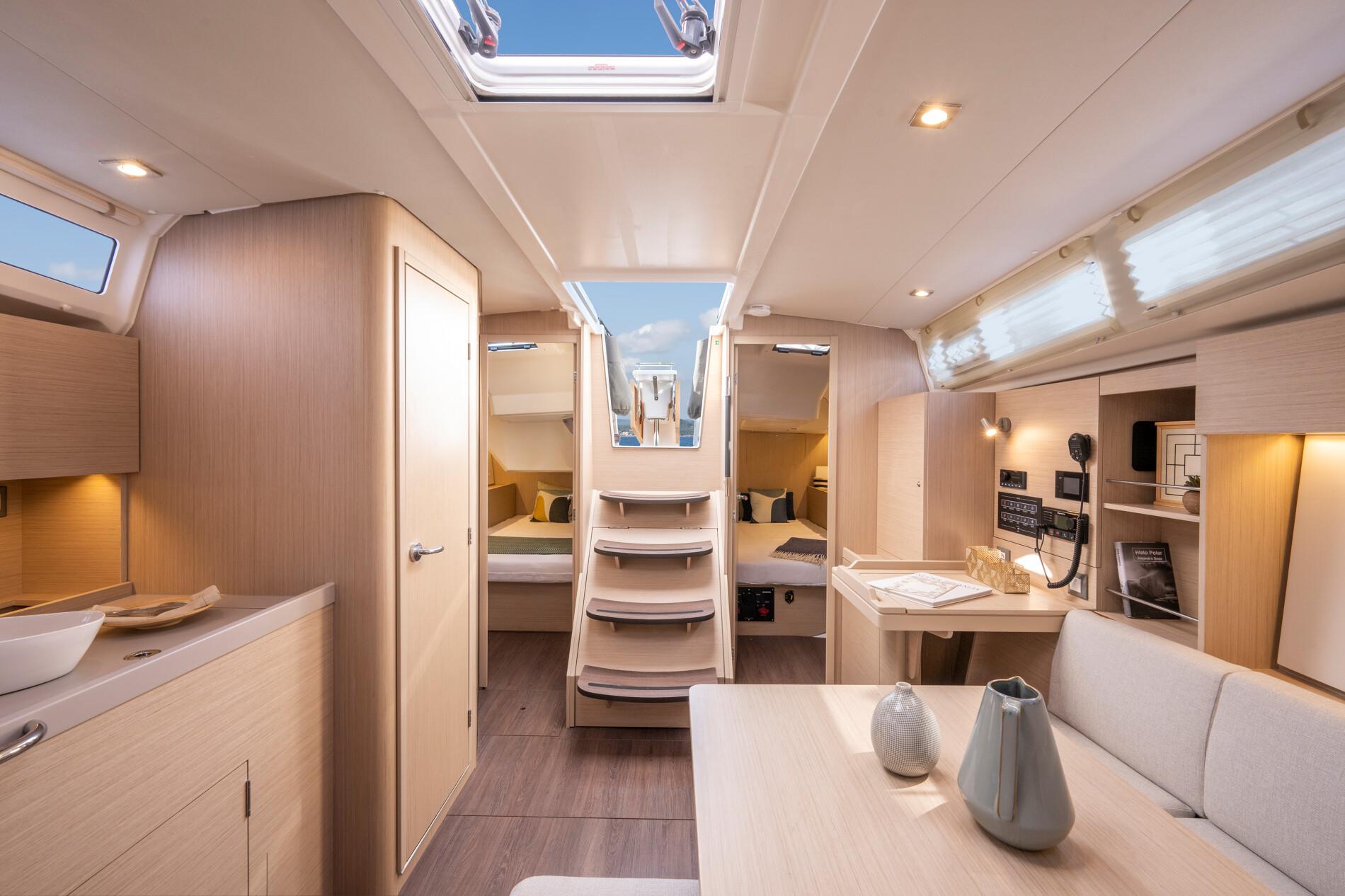Luxurious interior of 2025 Beneteau Oceanis 37.1 yacht, featuring modern design and cozy seating.