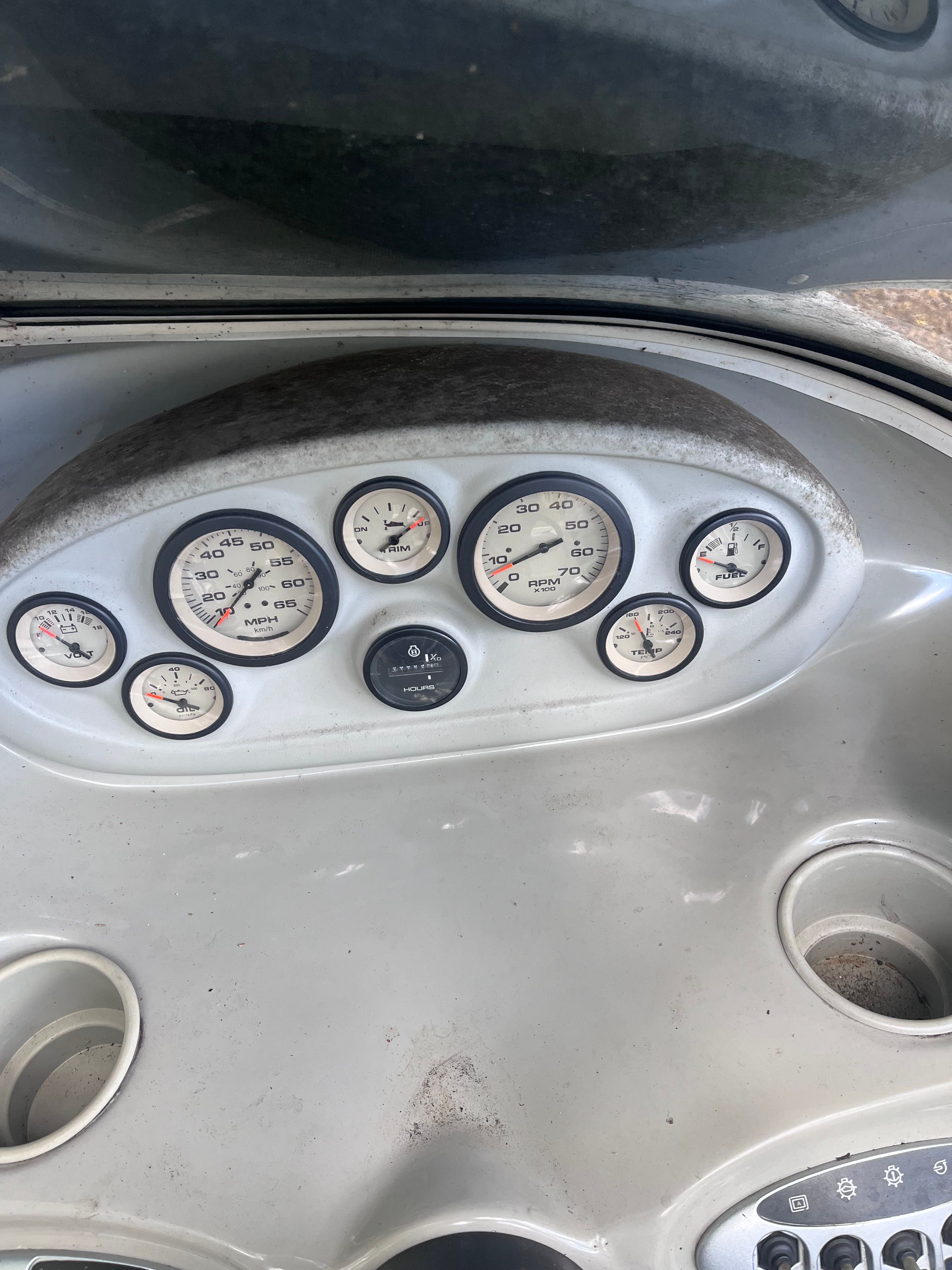 Dashboard of a 2005 Bayliner Cuddy Capri boat with gauges.